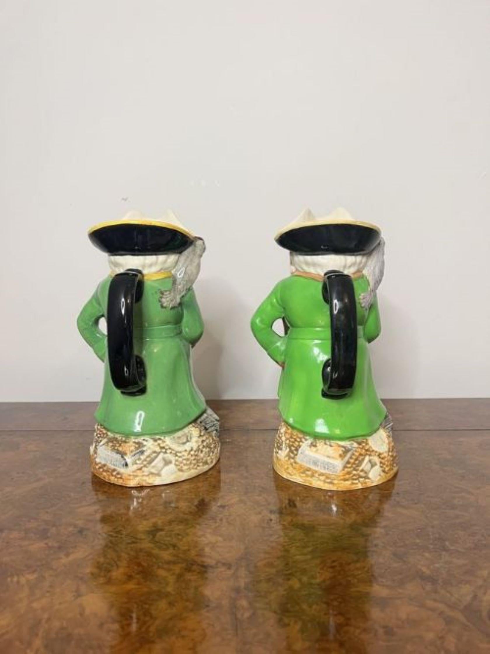 Pair of antique quality Staffordshire Toby jugs of Long John Silver with his parrot on his shoulder in vibrant green, yellow, black and red hand painted colours with a black handle to the back standing on circular bases.