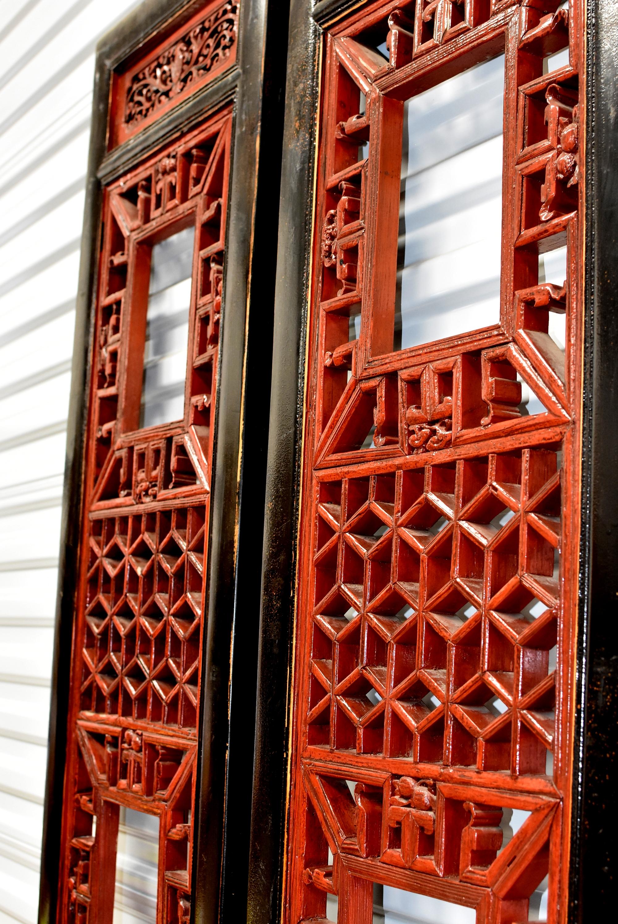 A pair of beautiful Chinese Antique screens in black and red lacquer. The main openwork was created using the painstaking joinery method. Every little piece is joined together by tenons and mortises, forming the famous 