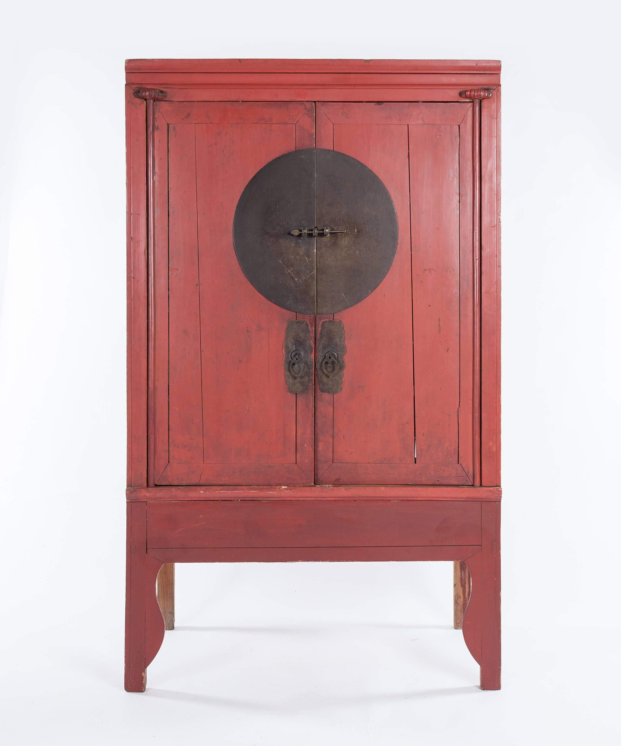 A pair of antique red lacquer Ming-style Chinese wardrobes dating to the second quarter of the 20th century. One wardrobe measures approximately 42
