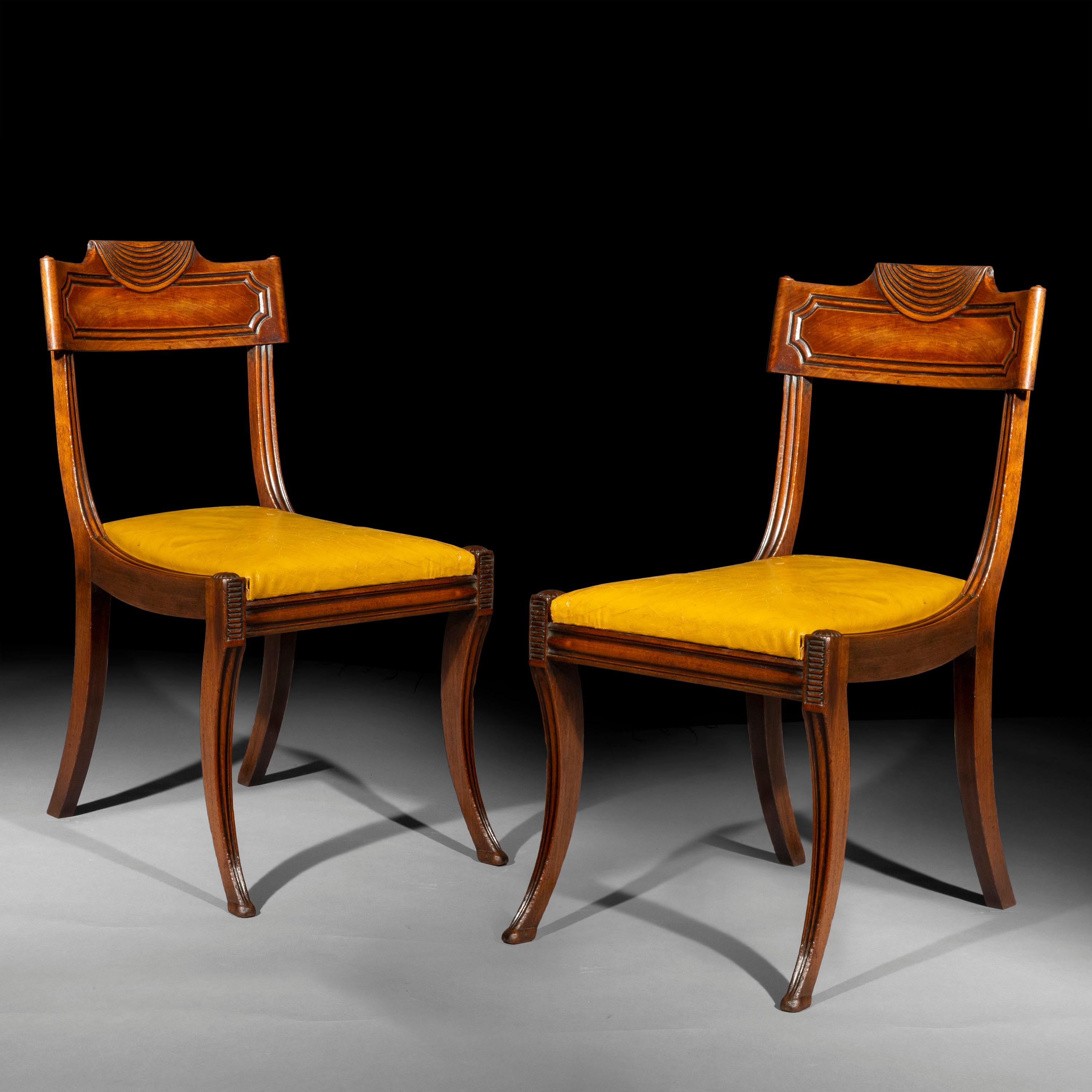 A rare and unusual Regency period pair of 'Klismos' chairs, in the manner of the London makers Marsh and Tatham.

England, circa 1810.

Why we like them
This model is one of the most elegant Regency chairs that we have handled. Their bold spread of