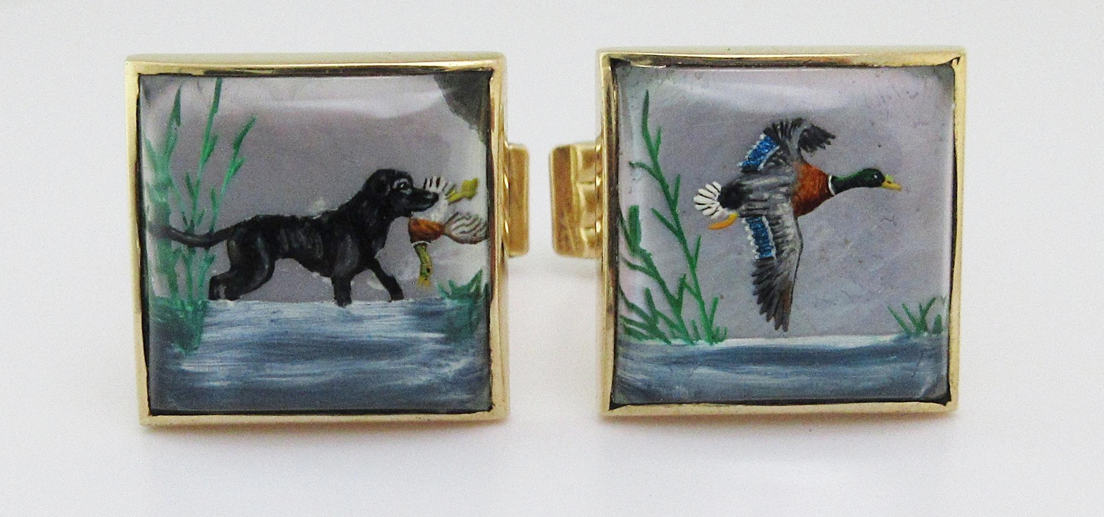 These spectacular examples of the finest of detailed work, composed of
two square hand carved rock crystal quartz reverse intaglio, each hand
painted in polychrome colors; one of a black labrador retriever in water
retrieving a duck; the other of a