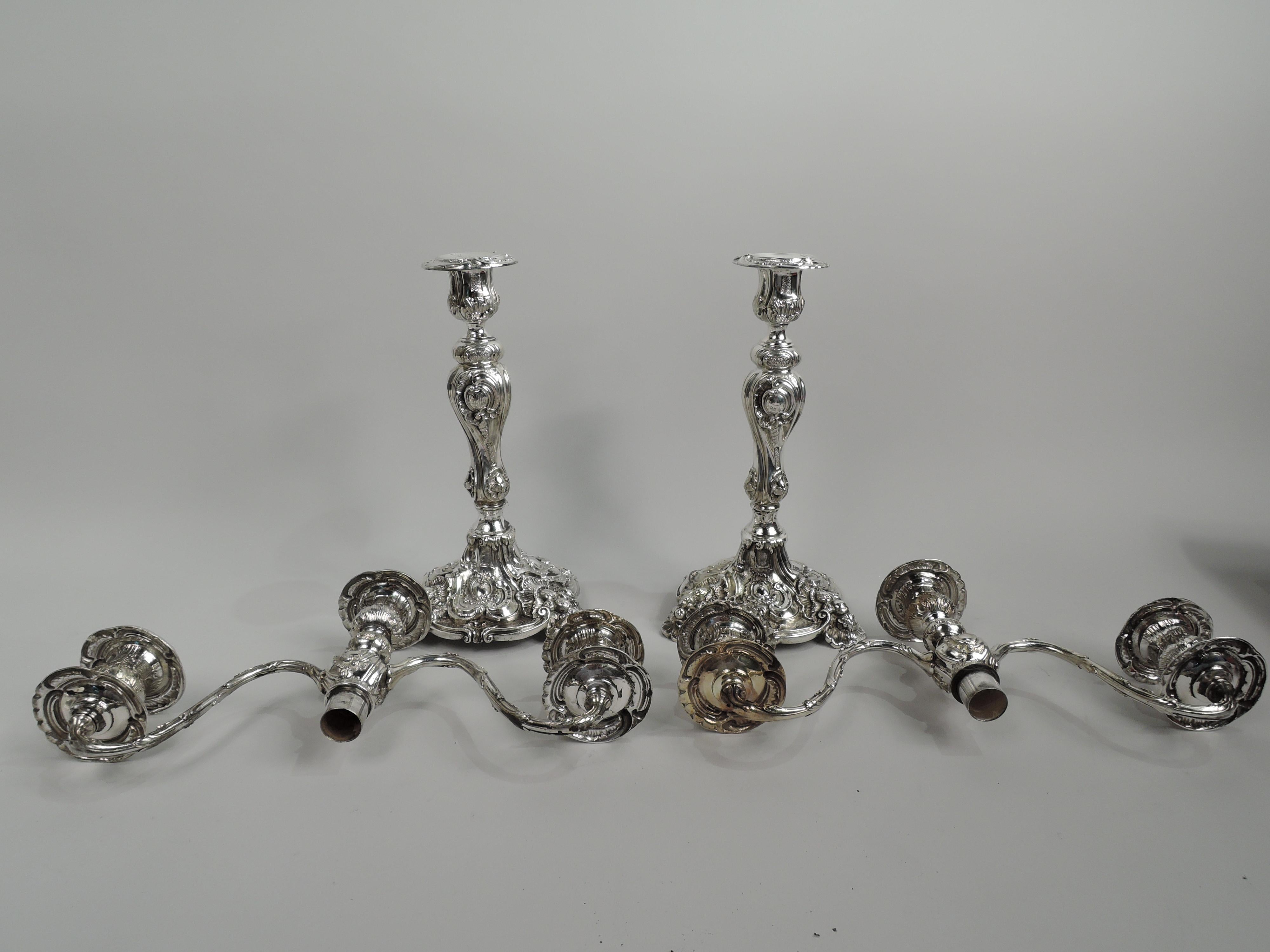 Pair of Rococo Revival sterling silver 3-light candelabra, ca 1928. Retailed by JE Caldwell in Philadelphia. Each: Raised socket on knopped baluster mounted with 2 leaf-wrapped s-scroll arms, each terminating in single socket. Sockets have
