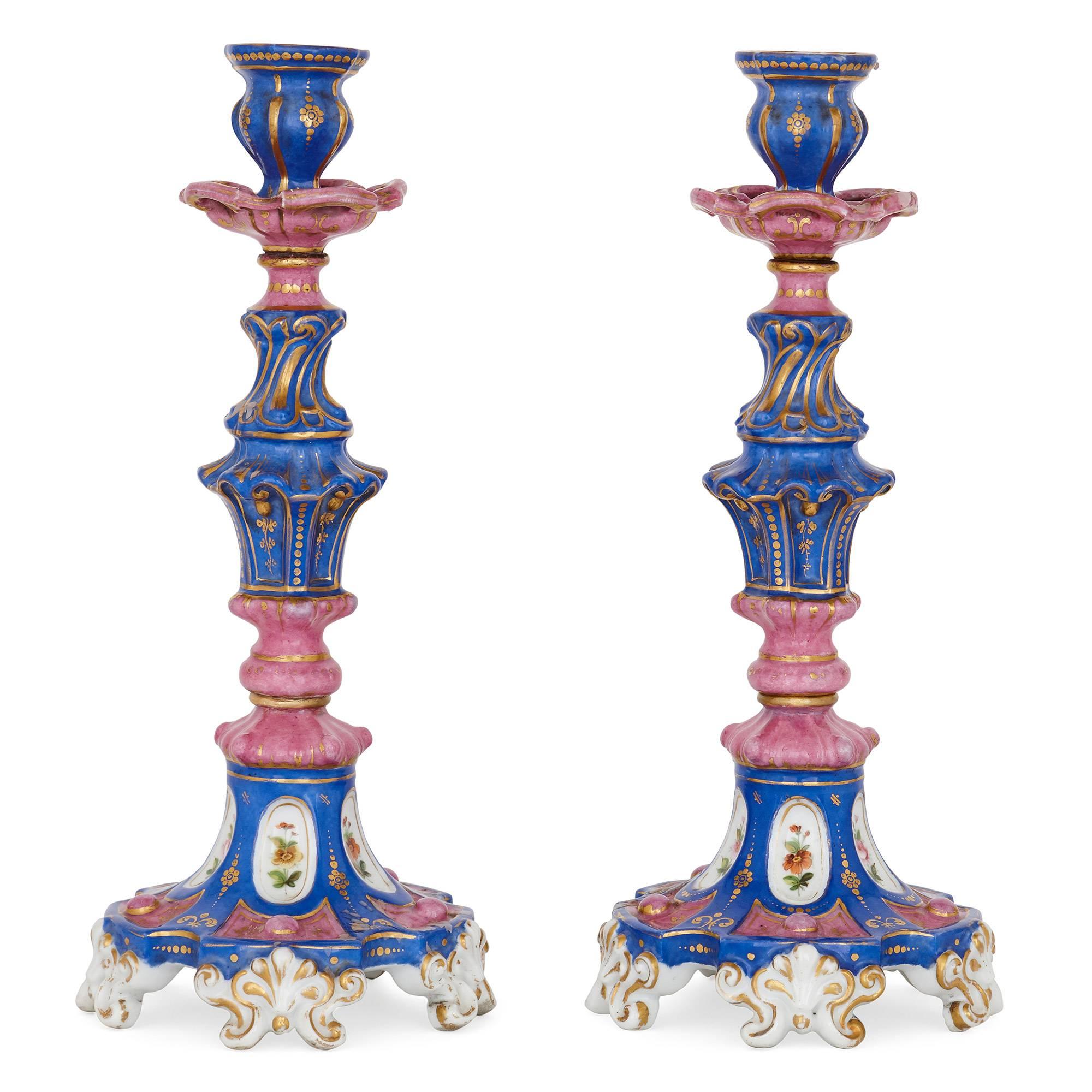 These exquisite porcelain candlesticks were made in the 19th century by the famous Russian Popov Manufactory.

The candlesticks are Rococo in their style. They feature knopped stems which are set on splayed bases on leaf-form feet. The stems