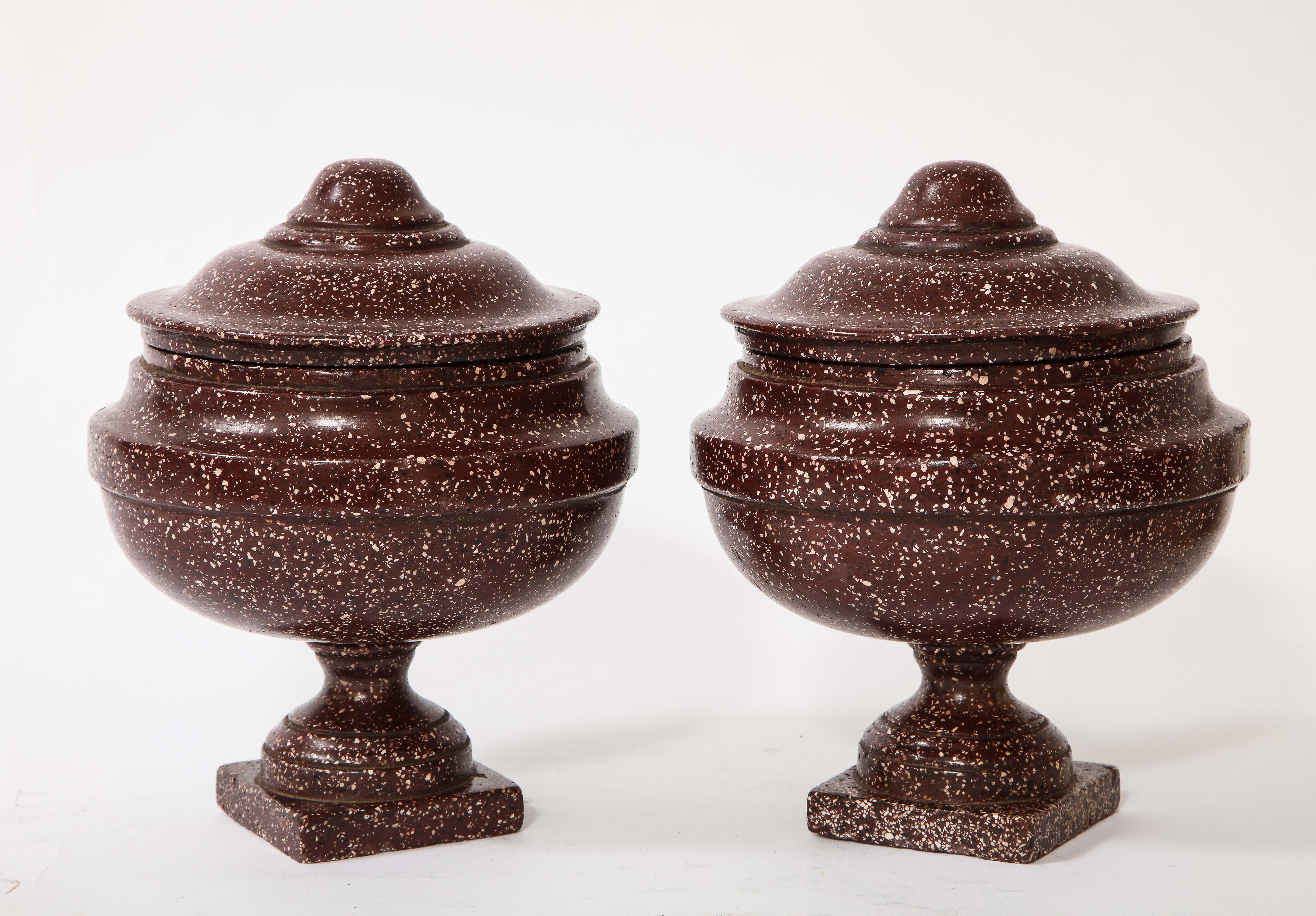 A very fine pair of antique roman porphyry, Grand Tour period hand carved lidded vases. These are a fabulous and quite decorative pair of porphyry lidded urns or vases. They are very well hand carved and hand-polished with variable stepped levels