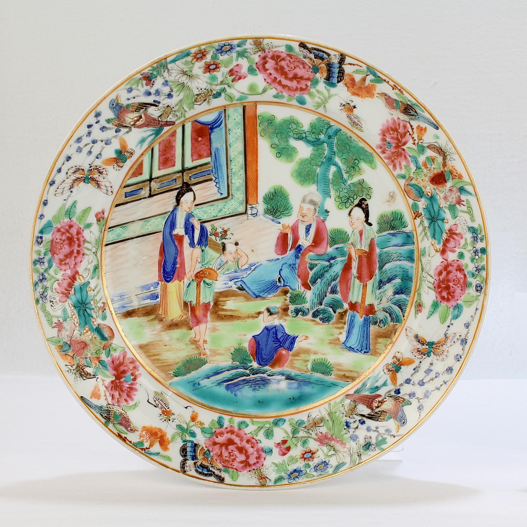 A fine pair of antique Chinese export porcelain plates.

In the Rose Mandarin (Famille Rose) style.

The central cartouche of both plates depict court scenes. 

On the first plate, the two young women on the left appear to be receiving a