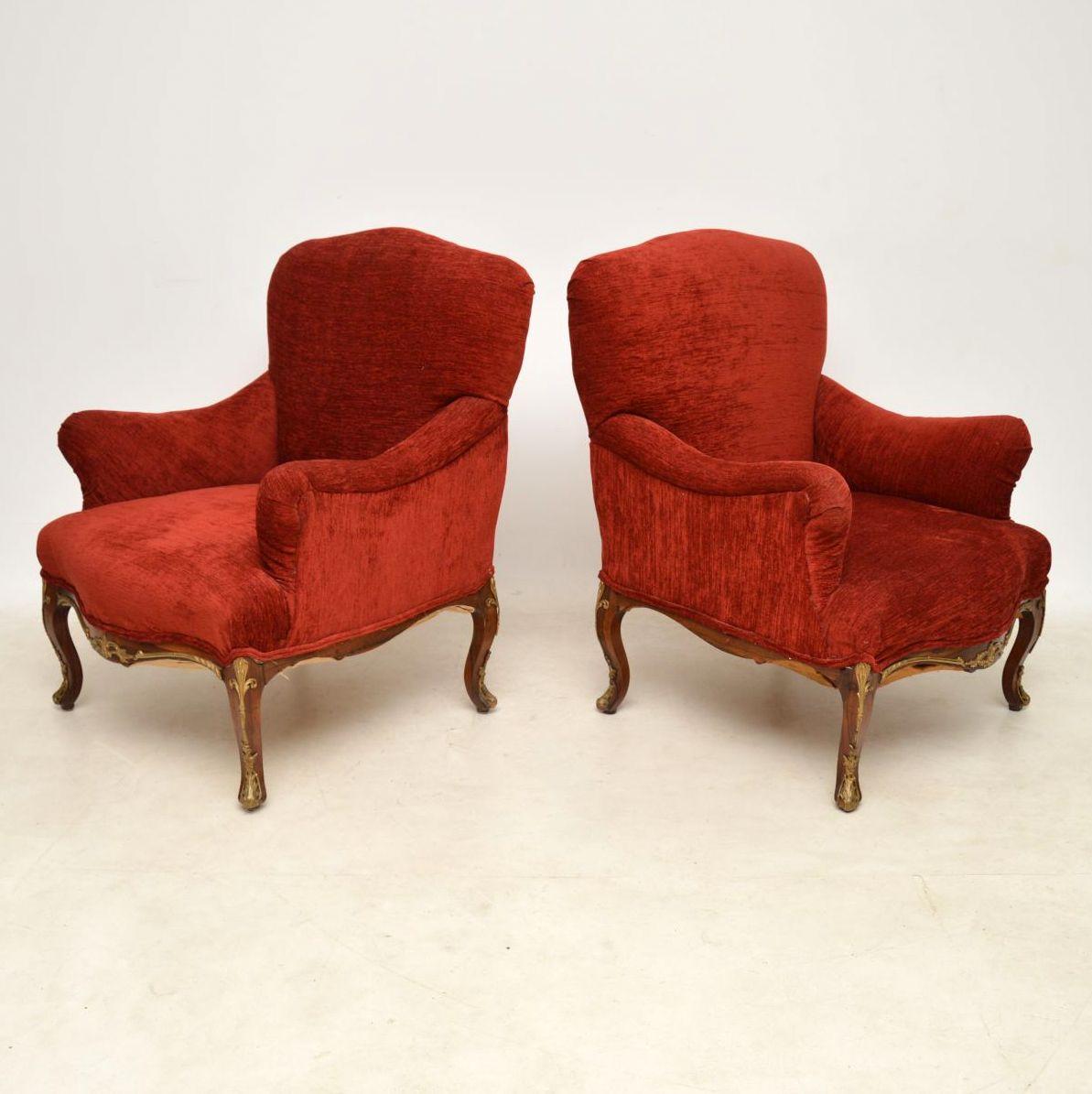 Fabulous pair of antique fully upholstered armchairs with rosewood legs that have applied gilt bronze mounts. They are wonderful quality and still have the original crisp horse hair beneath the fabric, which must have been redone quite recently
