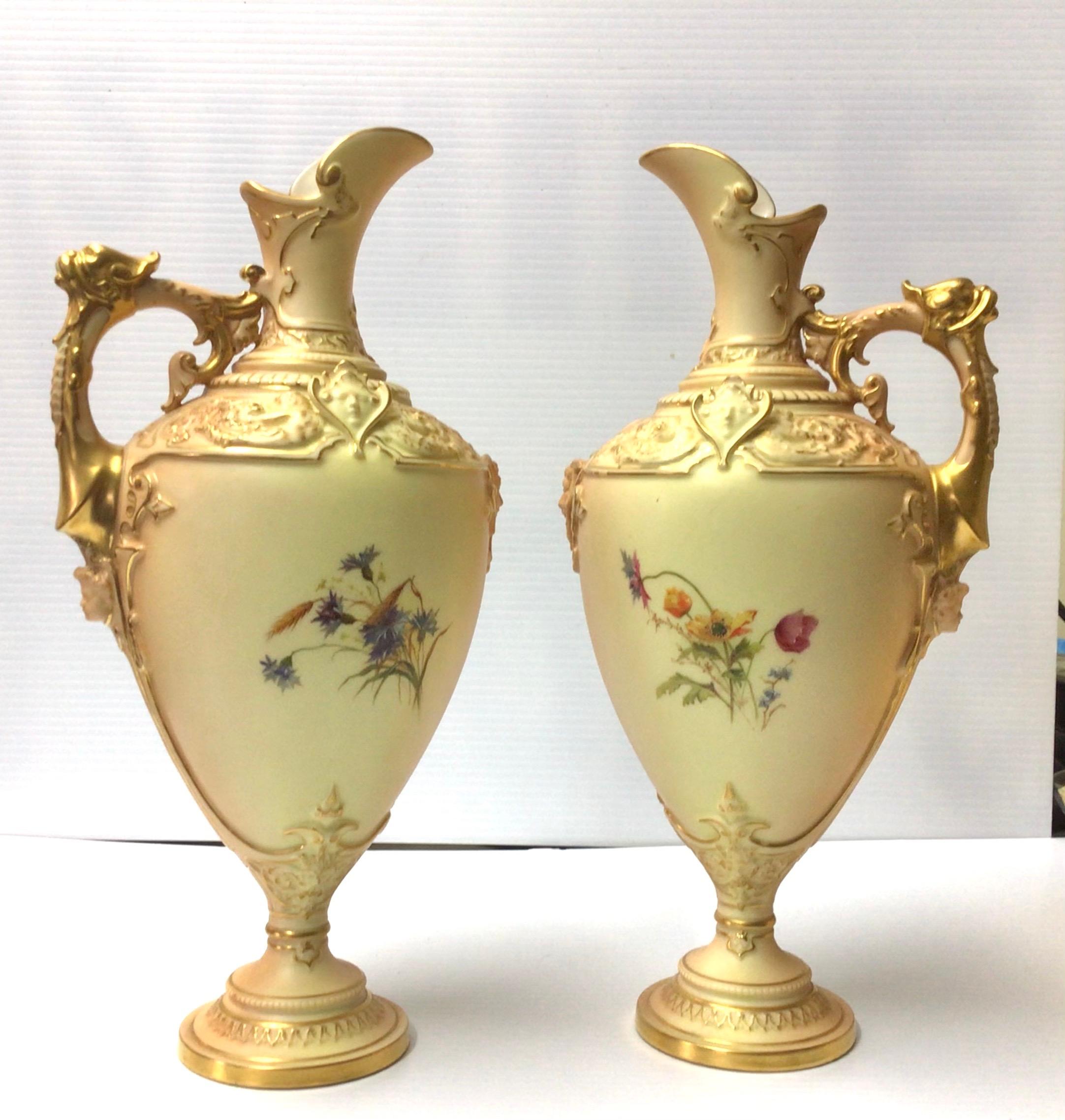 A beautiful pair of antique Royal Worcester blush ivory pedestal vases,ewers, shape 1742, each decorated with a spray of flowers, each with moulded decoration to the shoulders, puce mark with.
date code for 1898, 
Measures: height 31.5cm x depth