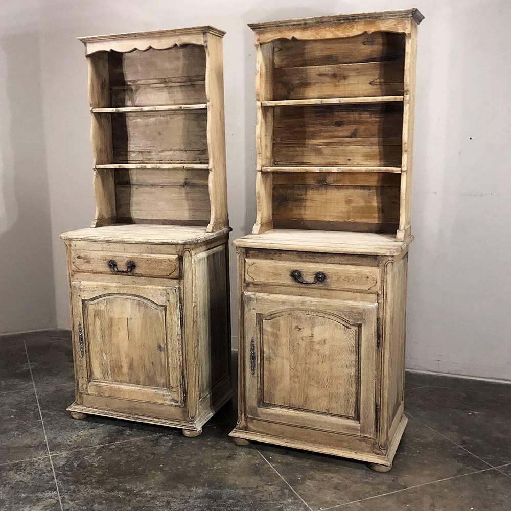 Pair of antique rustic Country French stripped Confiturier vaisseliers are a rare find, each barely 30 inches wide yet the height of a full size vaisselier! Hand-crafted from solid oak to last for generations, each features the traditional shelving