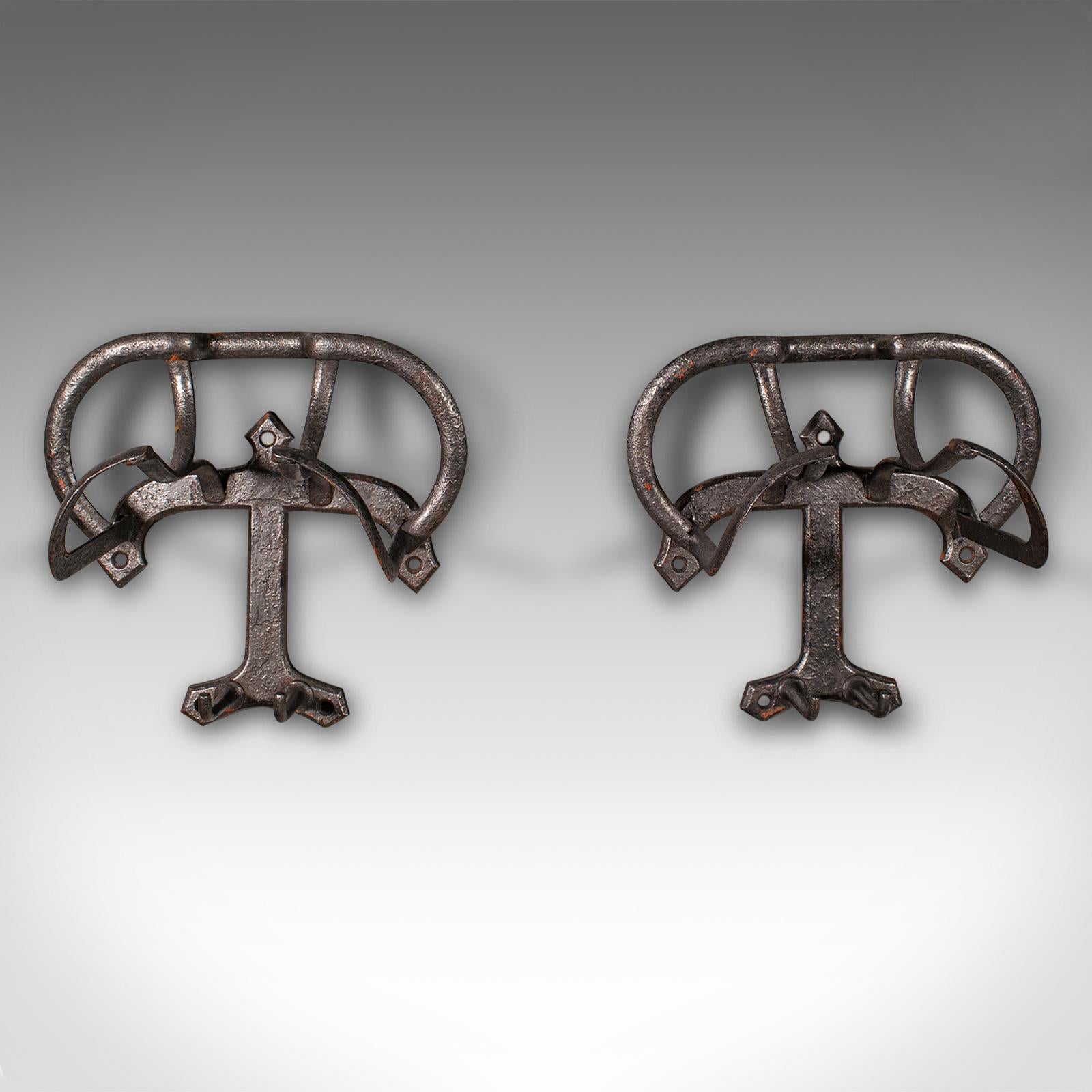 
This is a pair of antique saddle racks. An English, cast iron stable or outdoor equestrian tack rest, dating to the late Victorian period, circa 1900.

Traditional saddle racks with an appealing weathered finish
Displaying a desirable aged patina