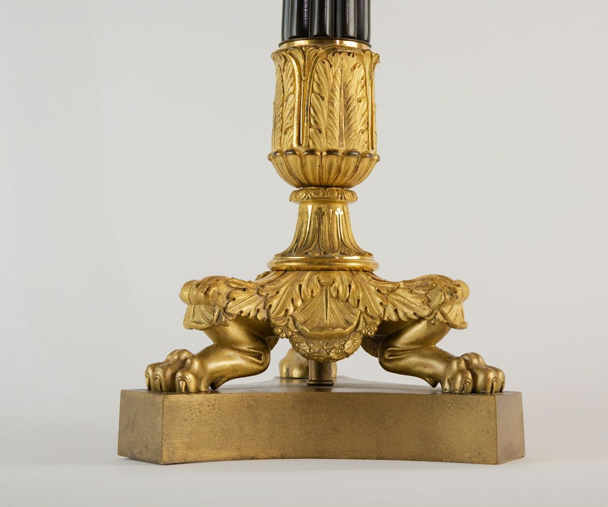 Offered is this wonderful neoclassical Empire style pair of candelabras with lion feet. Without a doubt, one of the most remarkable characteristics of these candelabras is the quality of the bronze castings and the excellent gilding that has