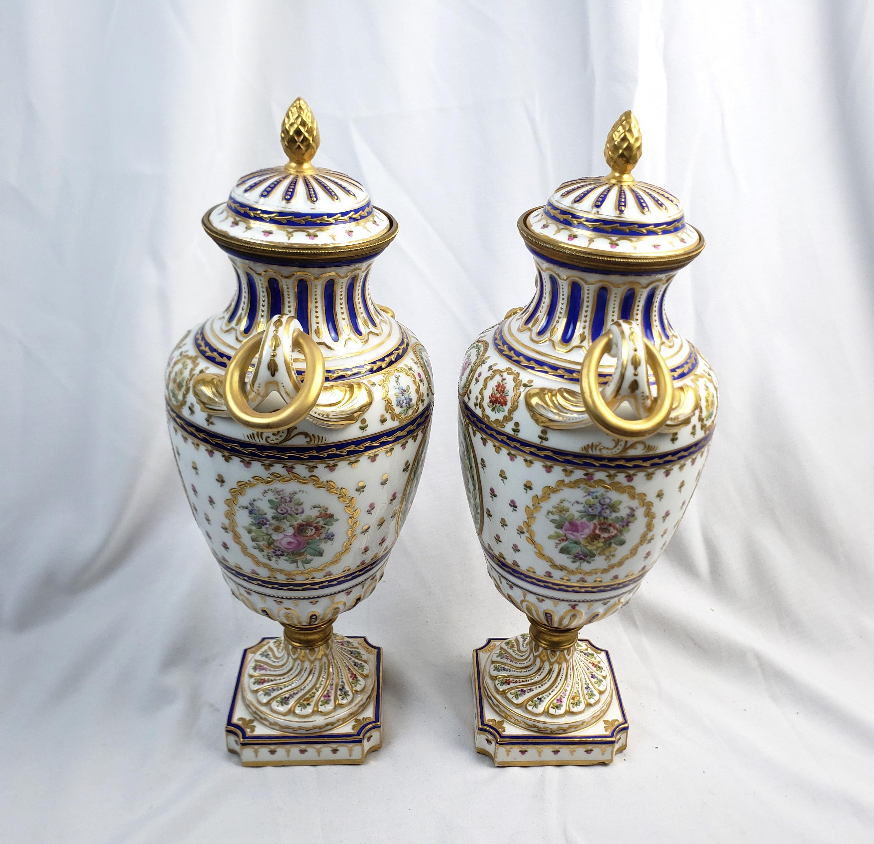 Porcelain Pair of Antique Sevres Styled Covered Urns with Ornate Hand-Painted Decoration For Sale