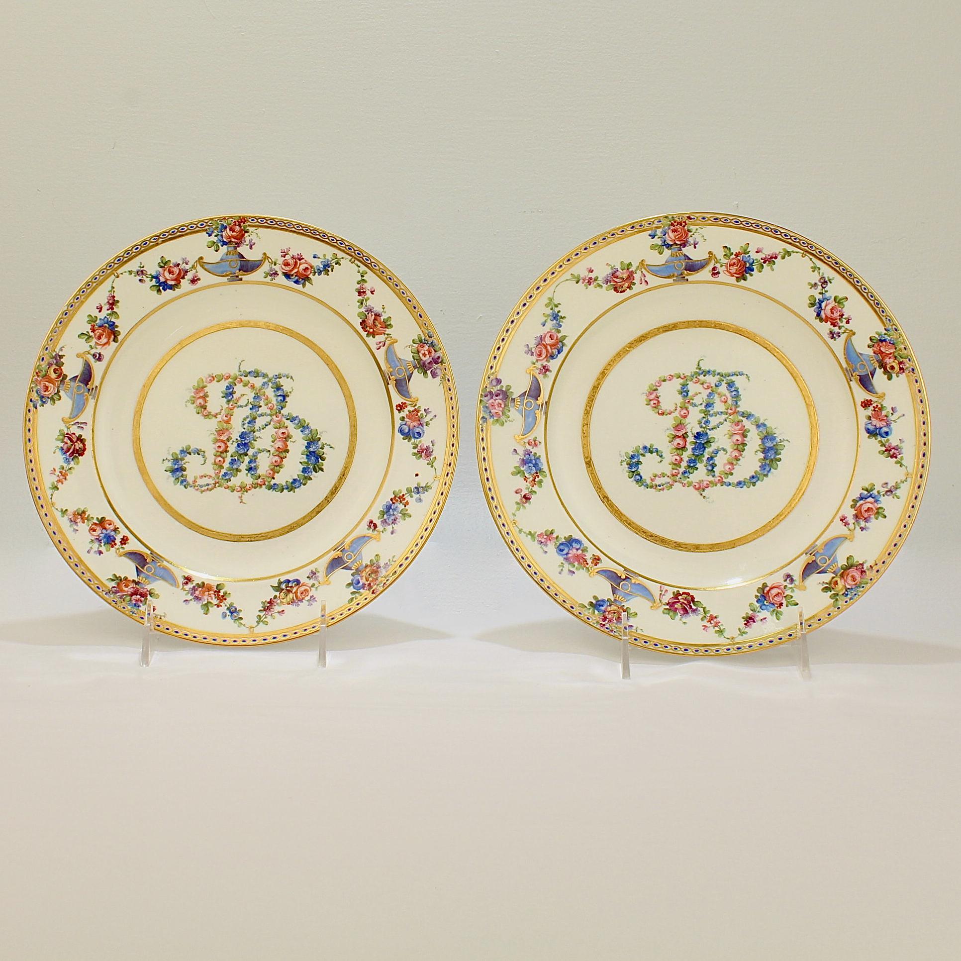 A very fine pair of 'Madame du Barry' Sèvres type porcelain plates.

Each decorated with a richly hand painted border of flower garlands, vines, and urns. 

The plates are a late 19th or early 20th century homage to the exceptional 18th century