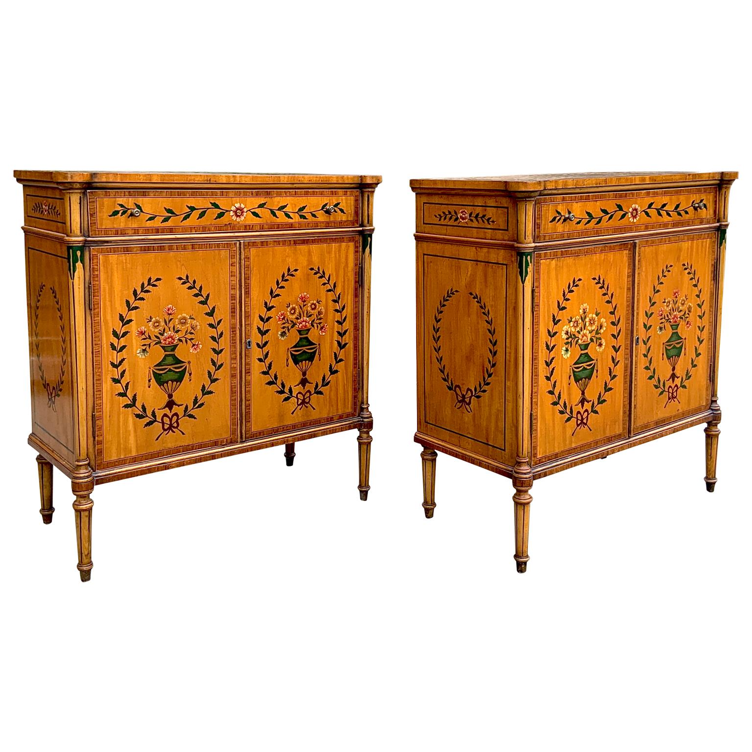 A lovely pair of antique Sheraton style 1800s hand painted cabinets. Great design, very nice large size and can be used as cabinets or nightstands. Retains original keys. Each having a drawer and doors that open to a shelf inside. The hand painting