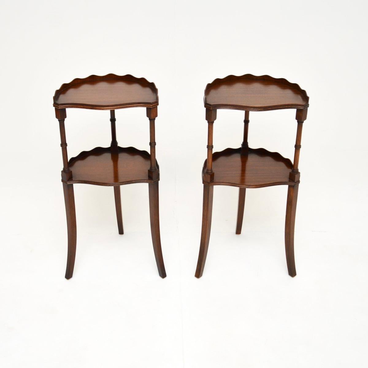 A beautiful pair of antique Sheraton style side tables, made in England, and dating from around the 1930’s.

They are of lovely quality, each has two tiers with raised pie crust edges. They are a very useful size and are nicely finished on all