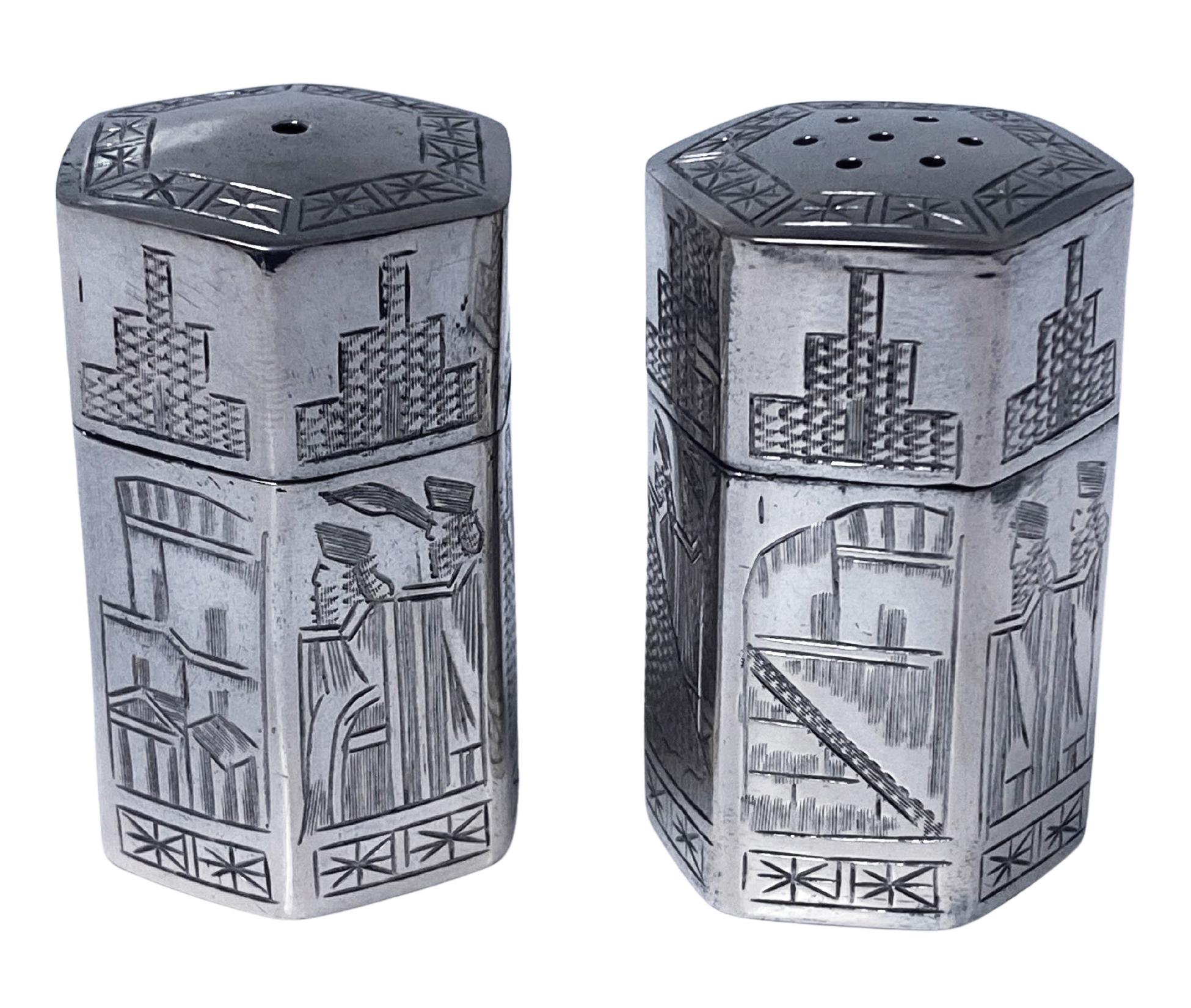 Pair of Antique Silver Casters Persia C.1920. Silver hexagonal salt and pepper shakers fully decorated with Assyrian motifs. 84 hallmarks on bases. Height: 1.75 inches. Weight: 57.16 grams. 