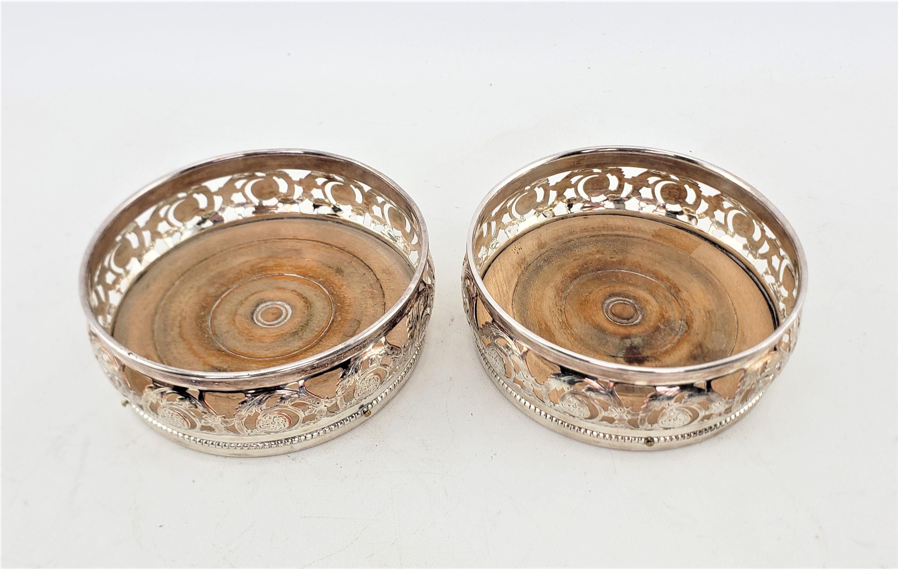 Victorian Pair of Antique Silver Plated Bottle Coasters with Floral Engraved Pierced Sides For Sale