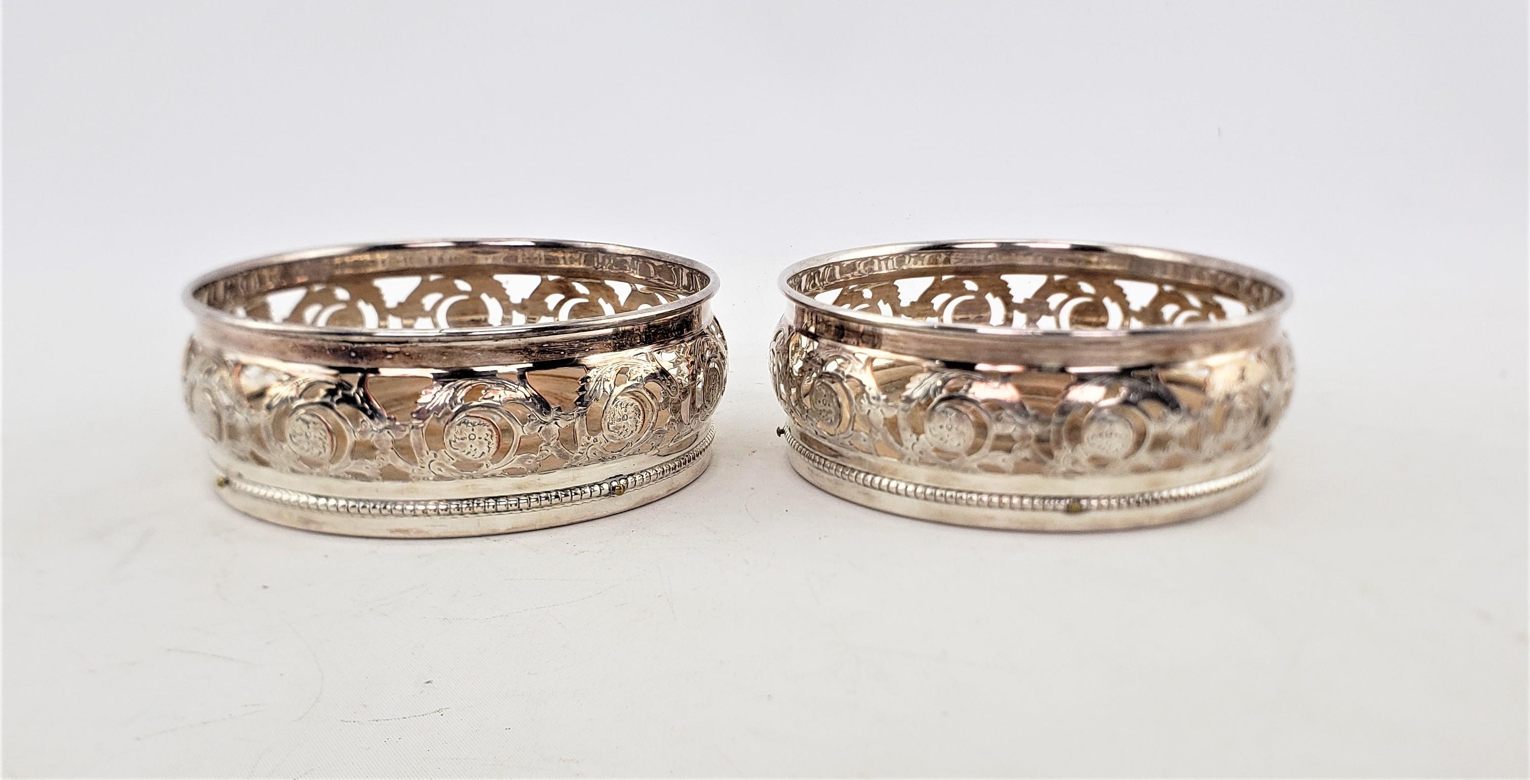 English Pair of Antique Silver Plated Bottle Coasters with Floral Engraved Pierced Sides For Sale