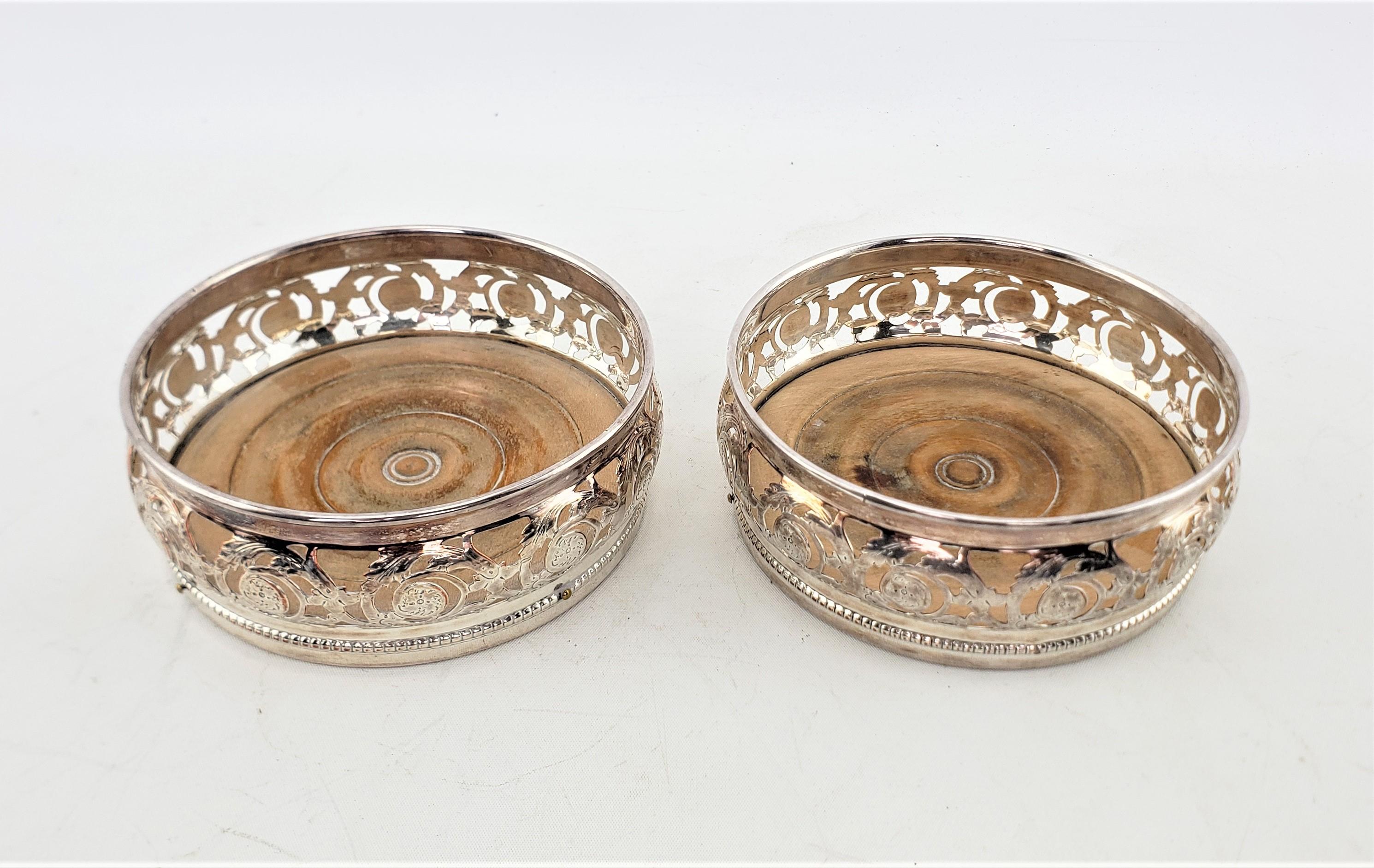 Machine-Made Pair of Antique Silver Plated Bottle Coasters with Floral Engraved Pierced Sides For Sale