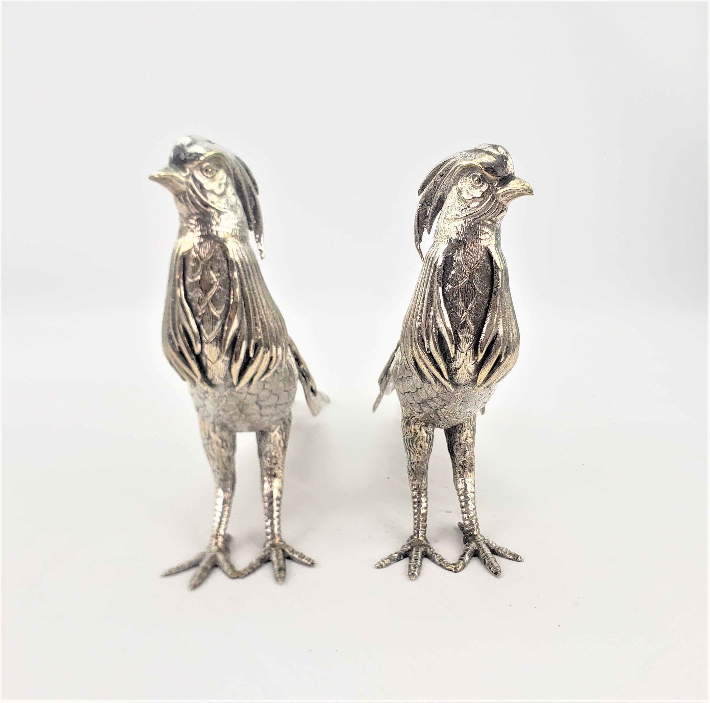 This pair of antique silver plated exotic bird or pheasant sculptures are unsigned, but presumed to have originated from Italy in approximately 1880 in the Victorian style. These ornately cast and silver plated birds are very detailed from all sides