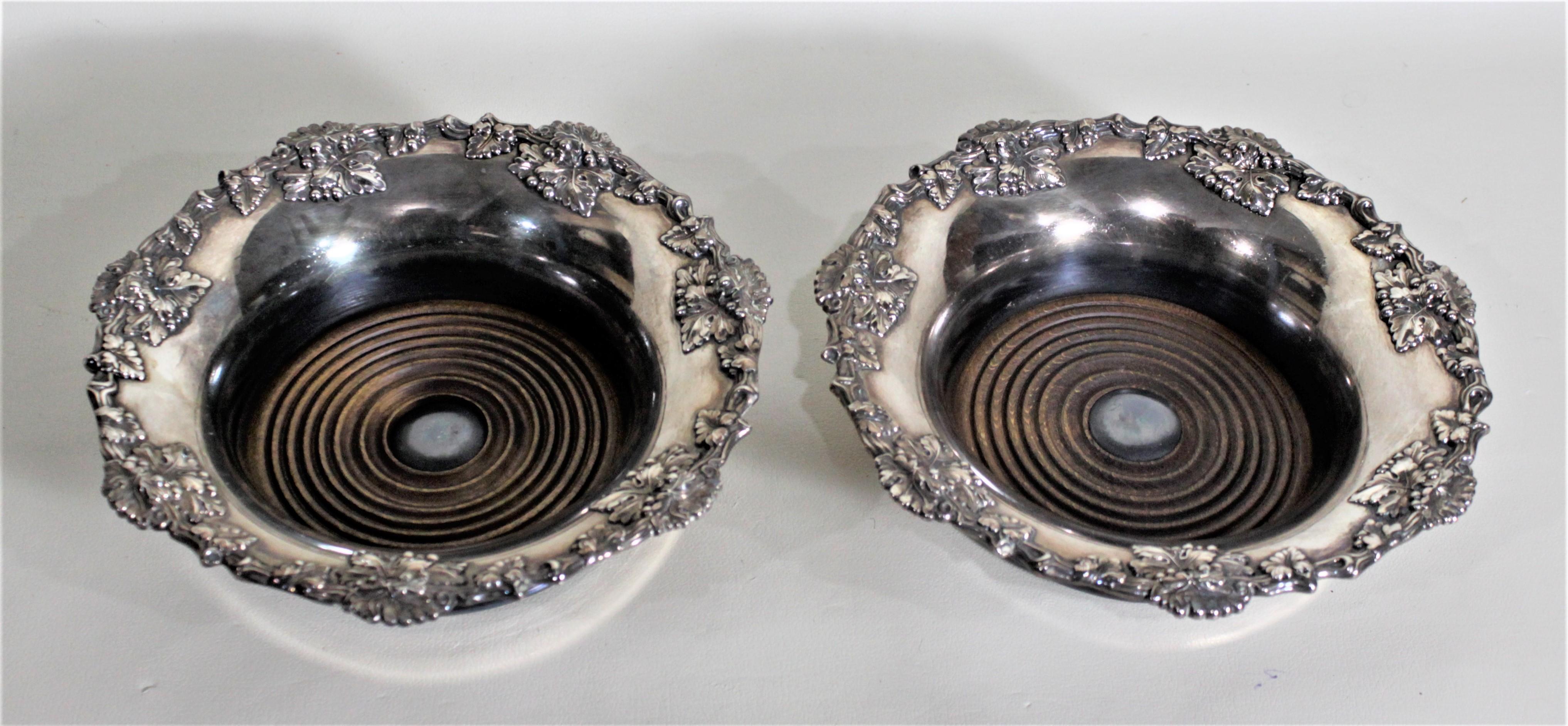 English Pair of Antique Silver Plated Wine Bottle Coasters with Leaf & Berry Decoration