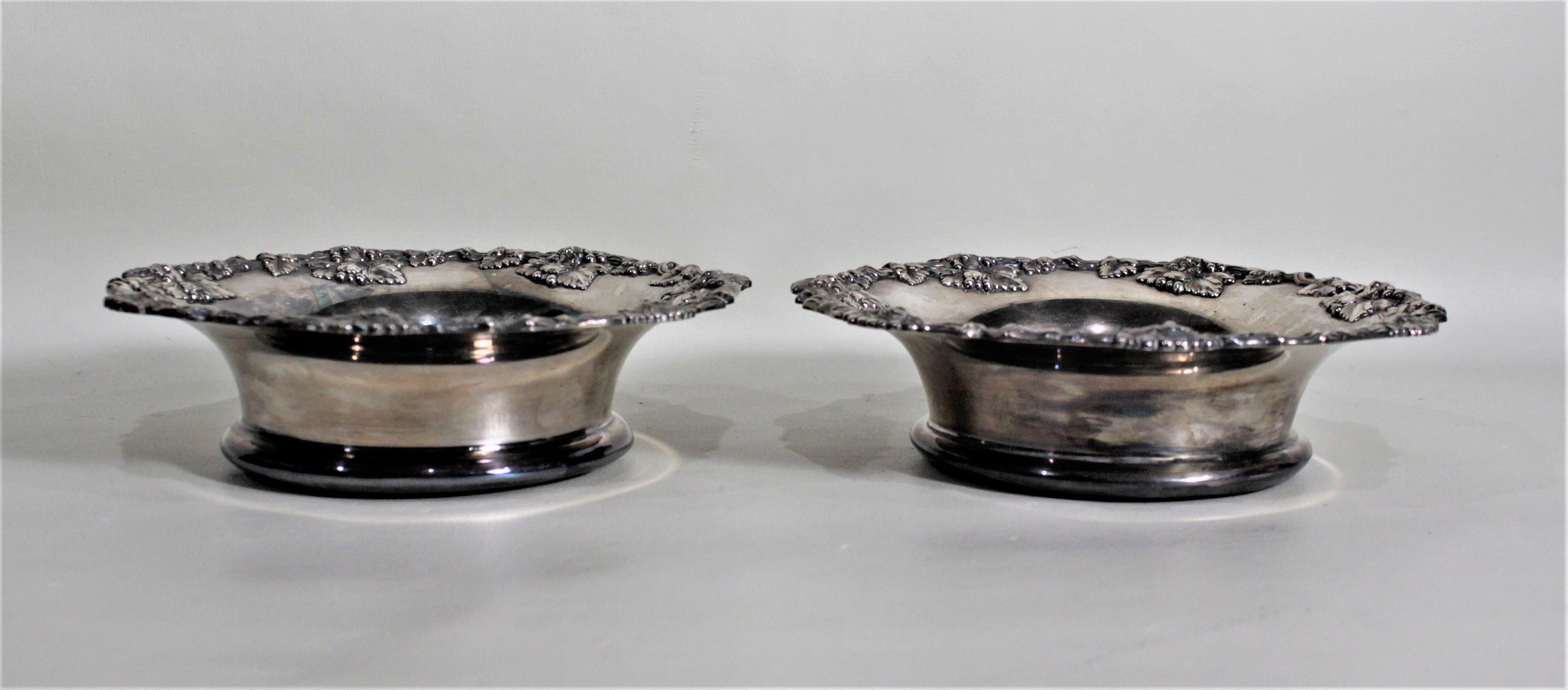 Machine-Made Pair of Antique Silver Plated Wine Bottle Coasters with Leaf & Berry Decoration