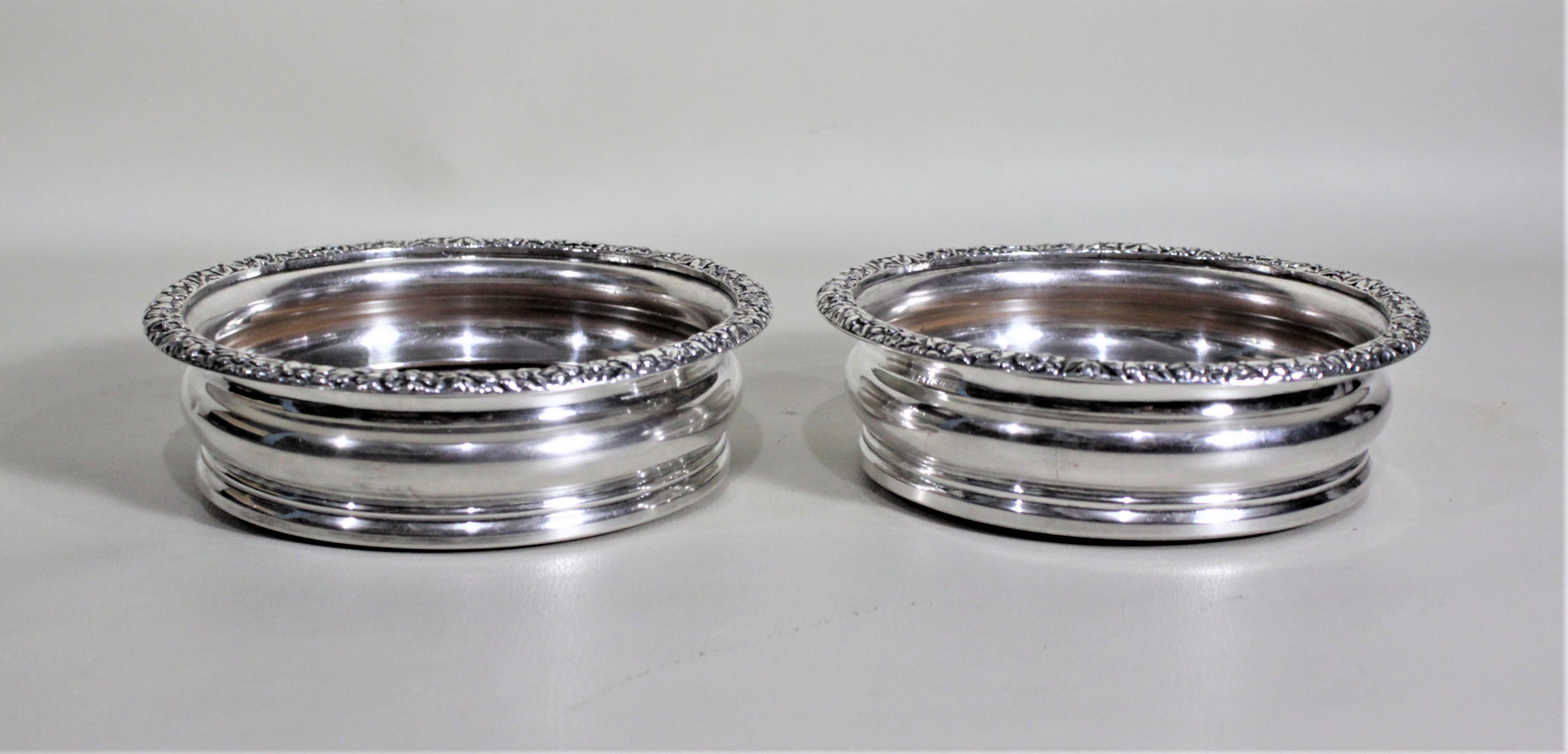 Machine-Made Pair of Antique Silver Plated Wine Bottle Coasters with Leaf & Berry Decoration