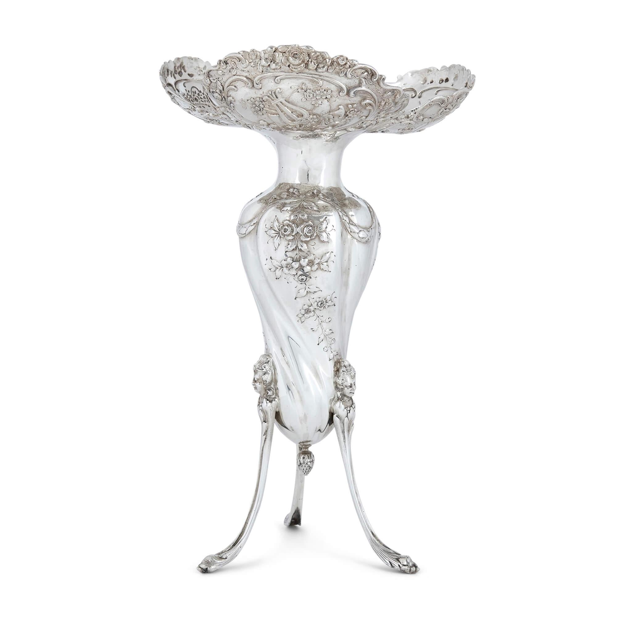 Pair of antique silver vases 
Continental, Late 19th Century 
Height 32cm, diameter 20cm

Crafted in the late 19th century, the design of these elegant vases is inspired by the Rococo style of the 18th century. 

The bulbous bodies taper towards the