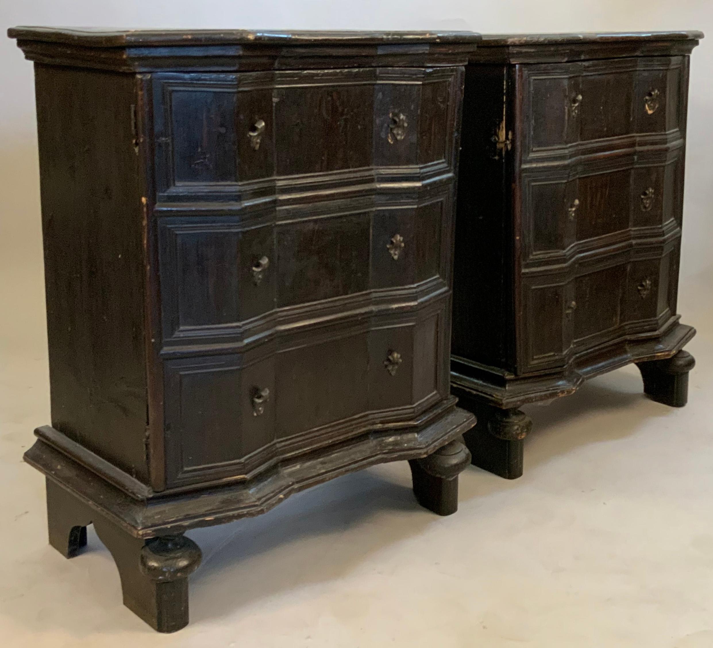 A very interesting and unique pair of late 19th century cabinets, with single doors made to appear as three drawer fronts. interiors fitted with shelves and covered with antique paper covering. the doors are angled and scalloped, and the cases are