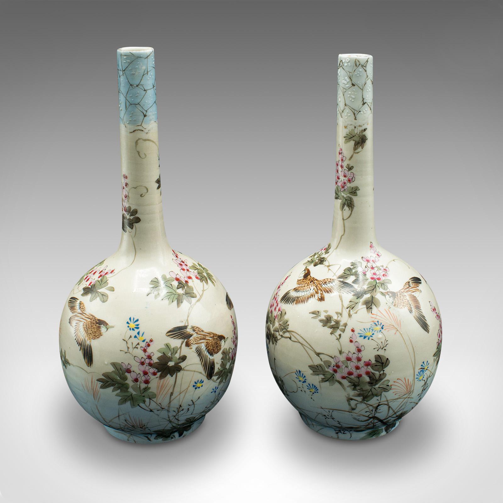 This is a pair of antique single stem vases. A Japanese, hand-painted ceramic baluster flower urn, dating to the Victorian period, circa 1880.

Delicately hand-painted decor from the early Meiji period
Displaying a desirable aged patina and in good