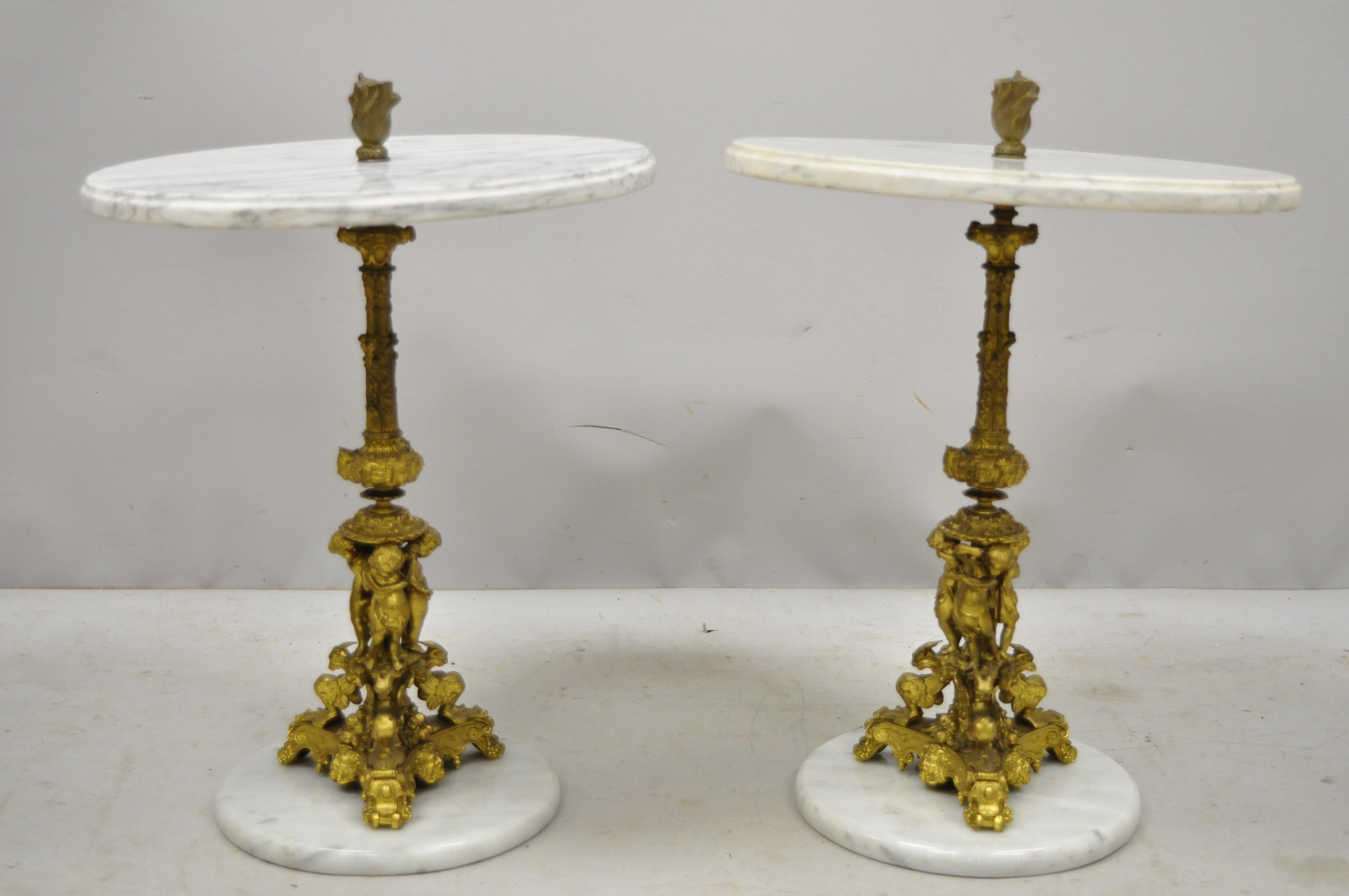 Pair of antique small bronze and marble figural Italian Renaissance side tables. Item features round marble top and base, cast bronze figural column supports of cherub musicians and various griffins and faces, nice small size, circa early 20th