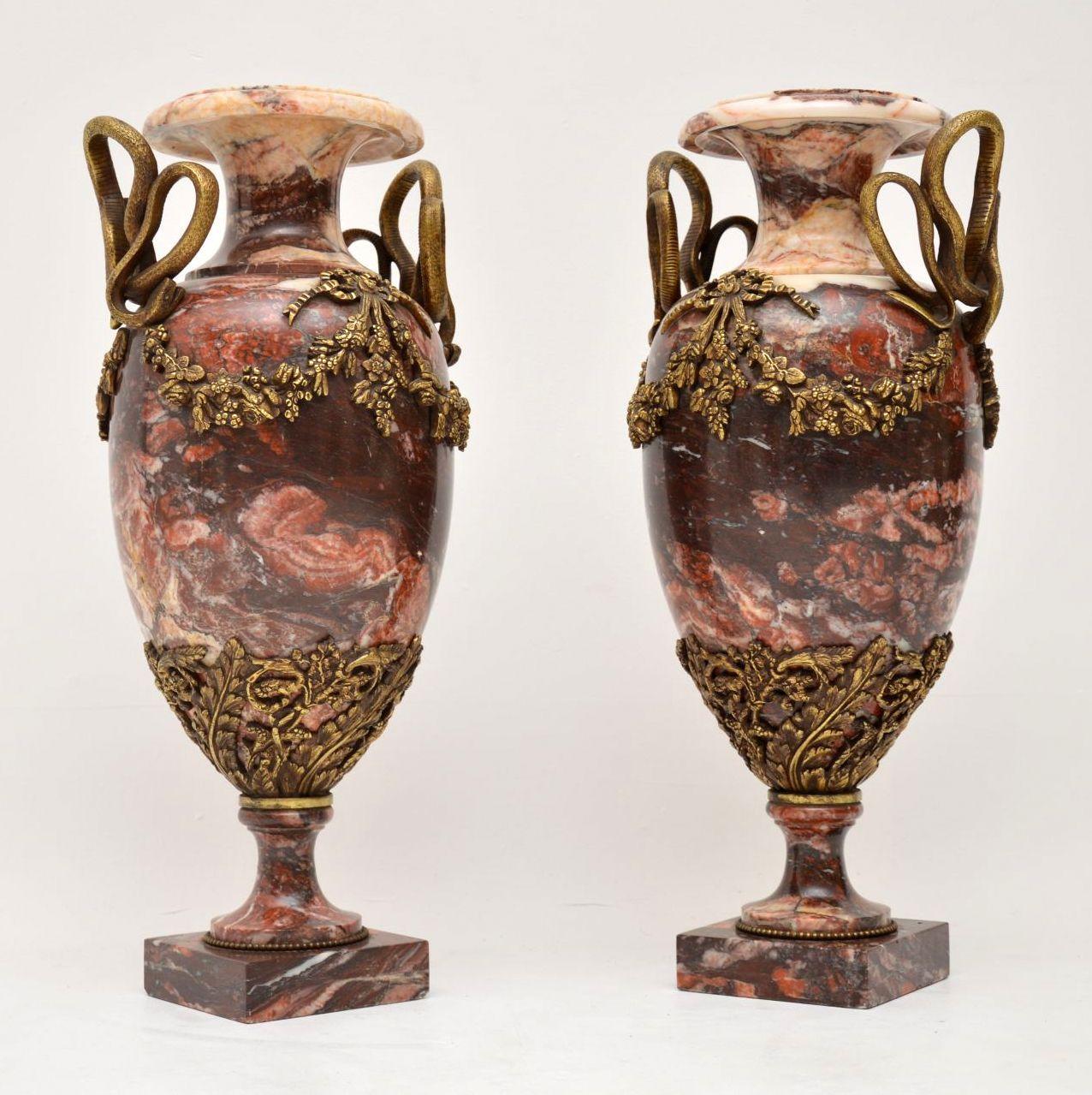 Very large impressive pair of 19th century antique rouge marble urns dating from circa 1860s period, give or take 20 years. They are in good condition with some slight damage which we have tried to show in the images, so please enlarge all the