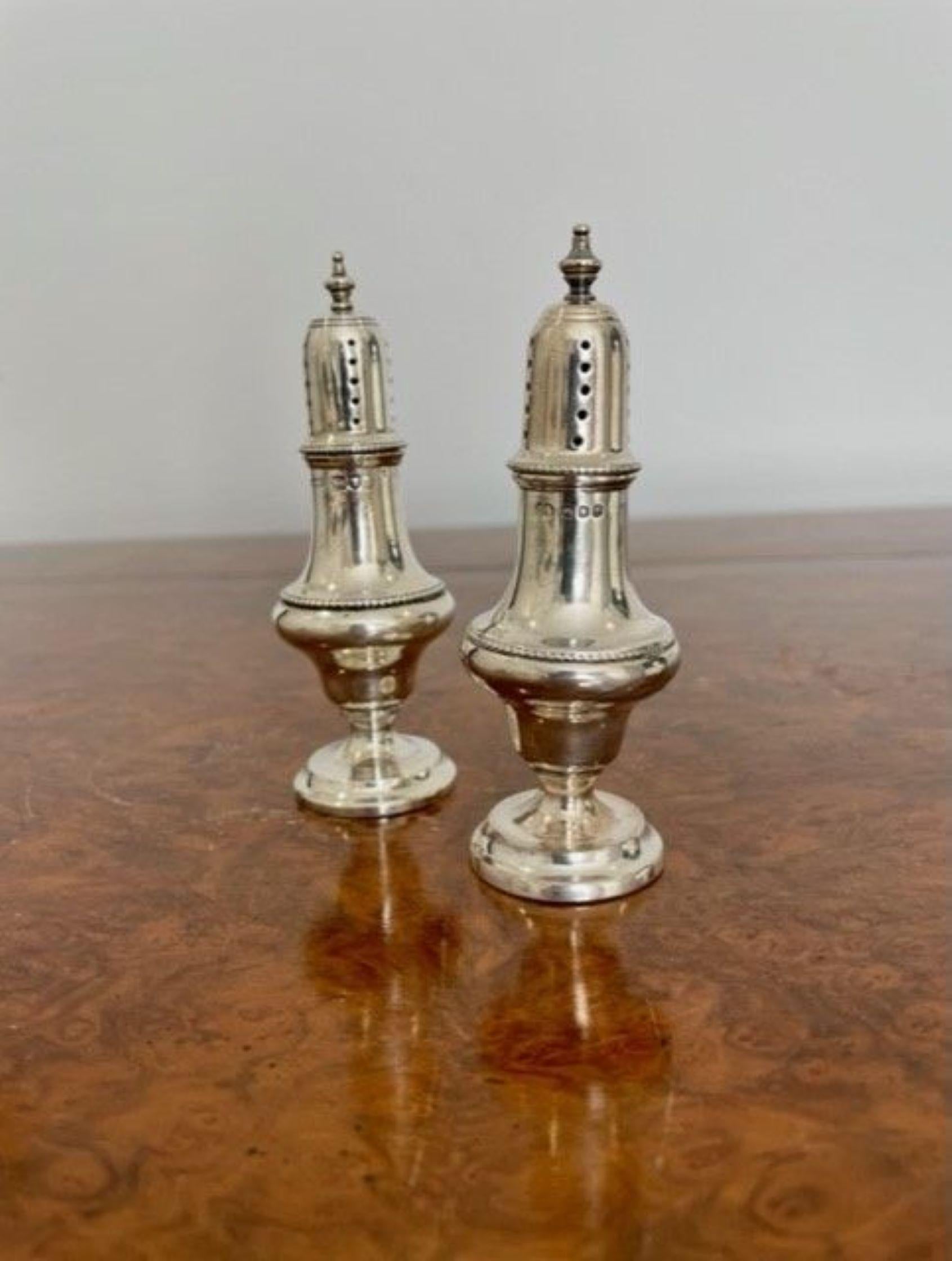 Pair of antique solid silver salt & pepper pots, having turned finials on the top, shaped beaded vessel centre, raised on a circular base, the pull off tops are hallmarked.