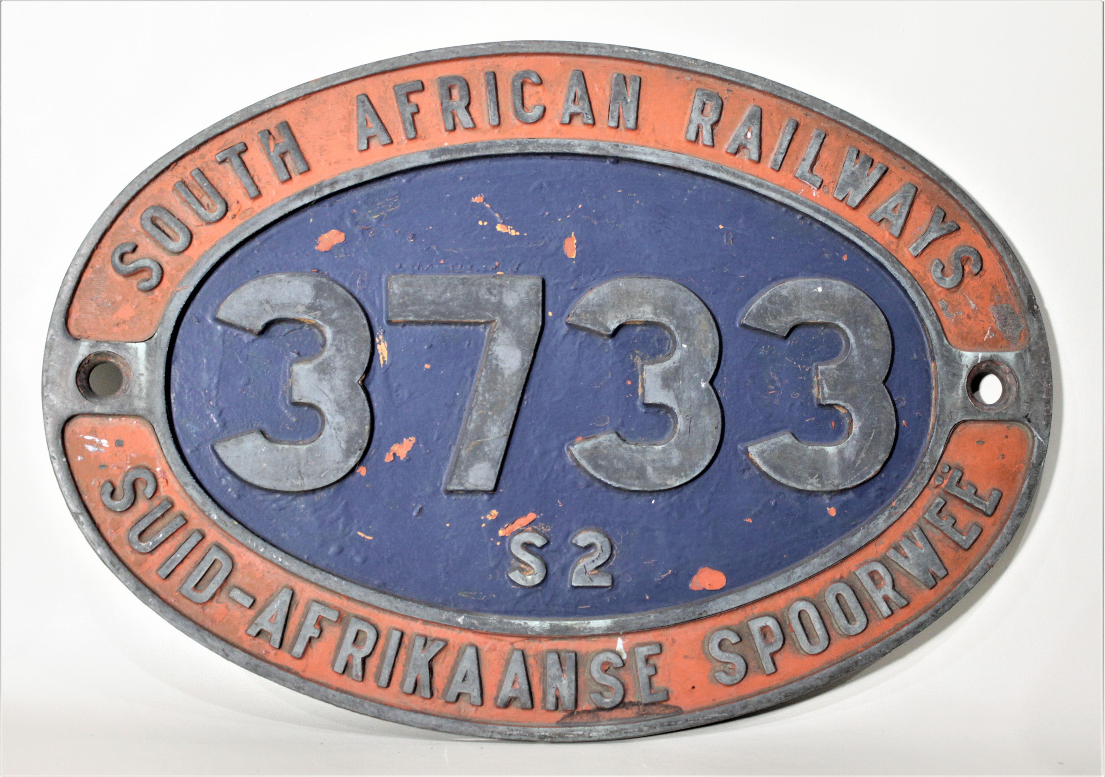 This large and substantial pair of cast and cold-painted locomotive identification plaques show no foundry marks, but are presumed to have been cast in South Africa in circa 1910. The badge 
