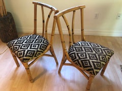 Pair of antique south seas bamboo chairs with polynesian hawaiian fabric
