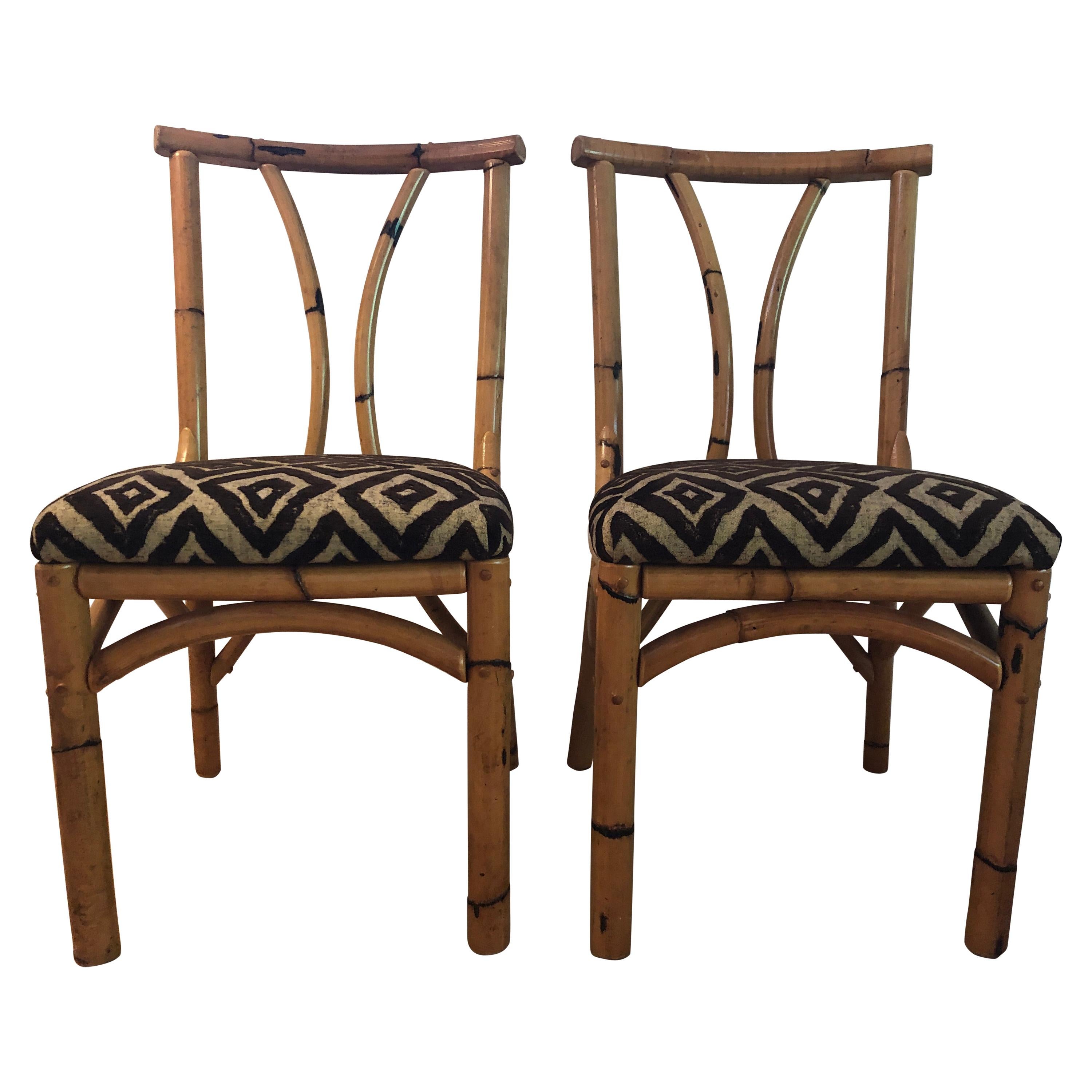 Pair of antique south seas bamboo chairs with polynesian hawaiian fabric For Sale
