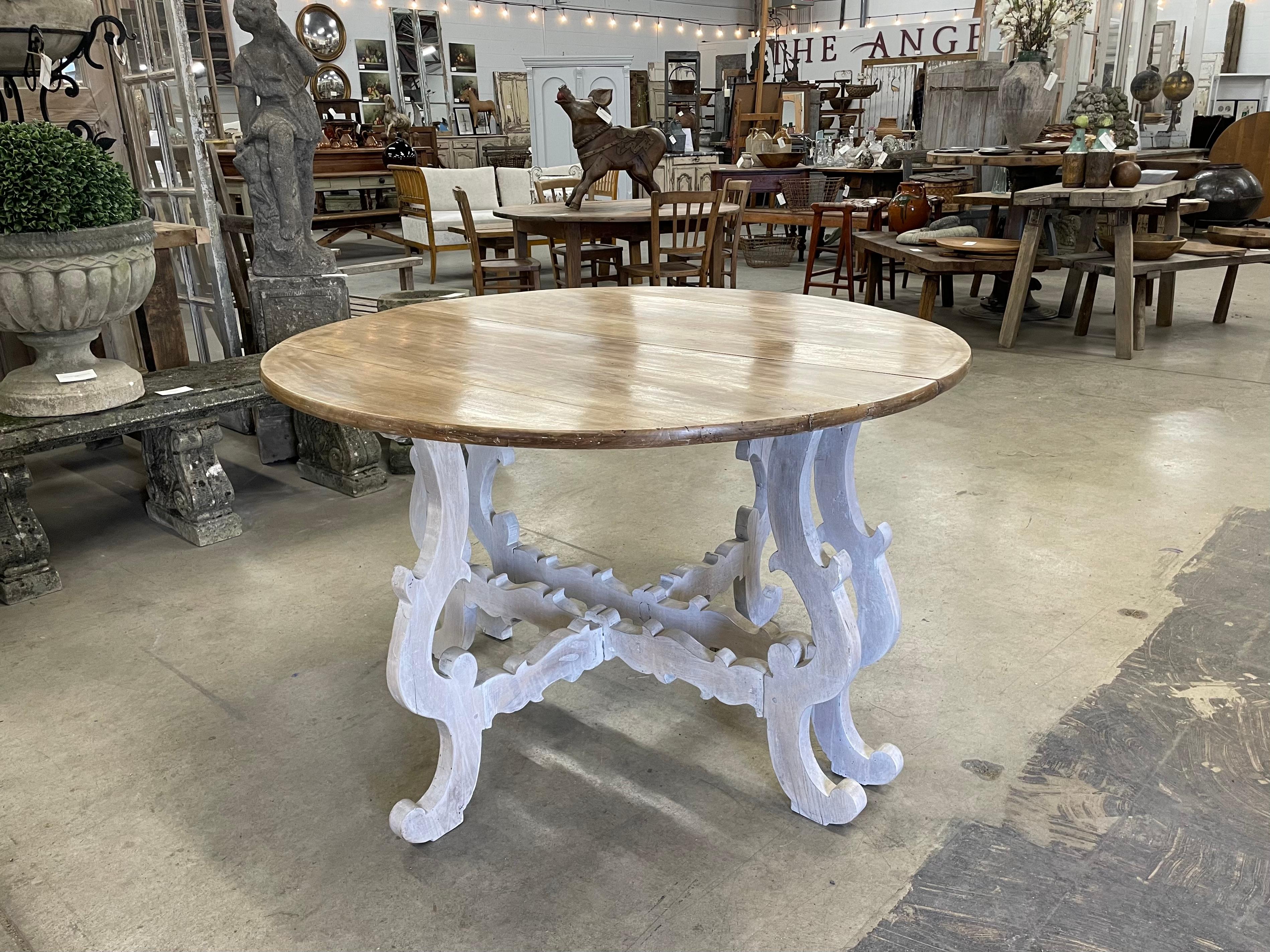 A pair of 19th century substantial Spanish Baroque style walnut console tables of exceptional quality. They can be stand alone demi-lune consoles or latched together to make a beautiful round table. The demi-lune tops are supported by decorative
