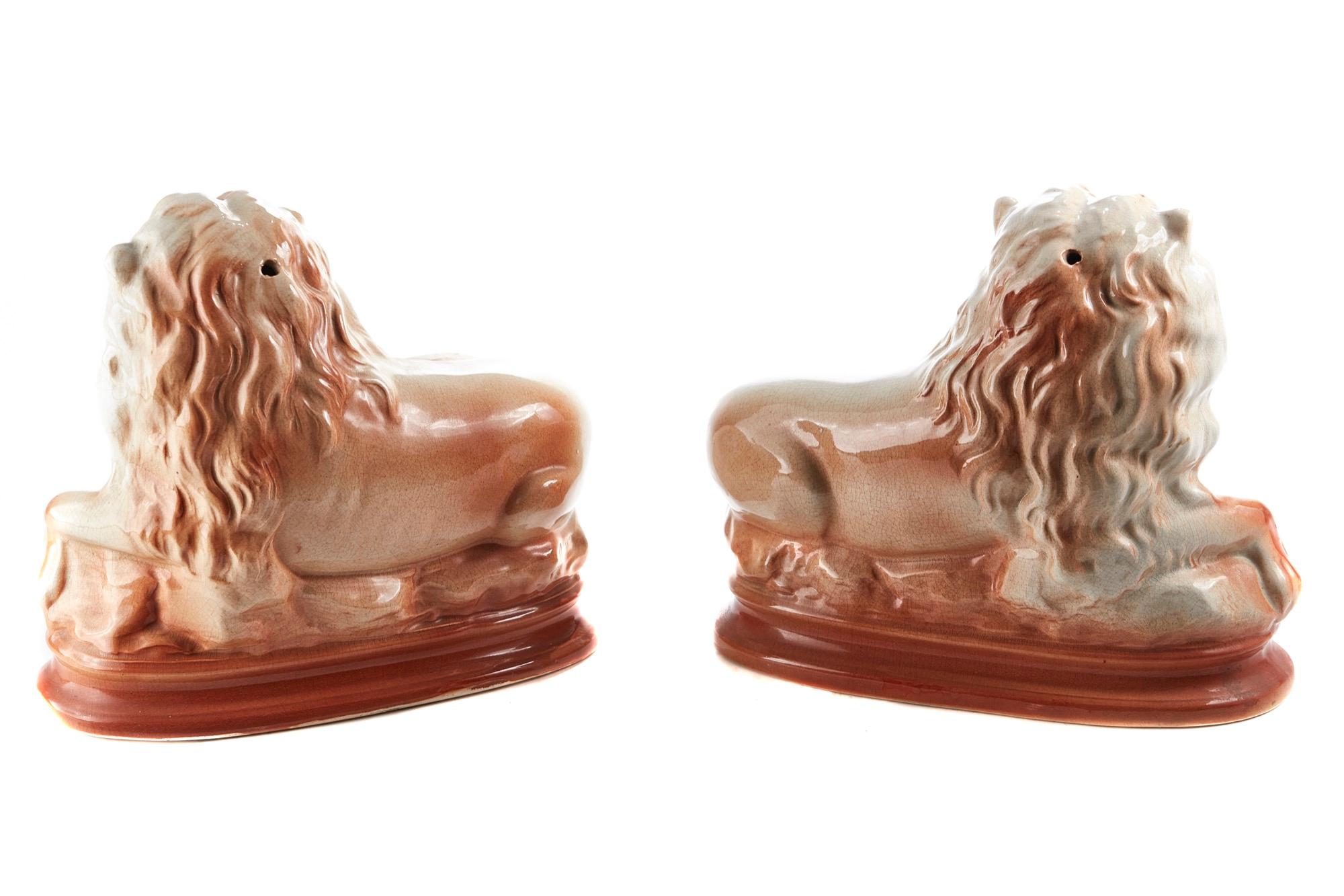 A fine pair of unusual antique Staffordshire lions which are beautifully designed and moulded with original glass eyes.

In perfect condition.
  