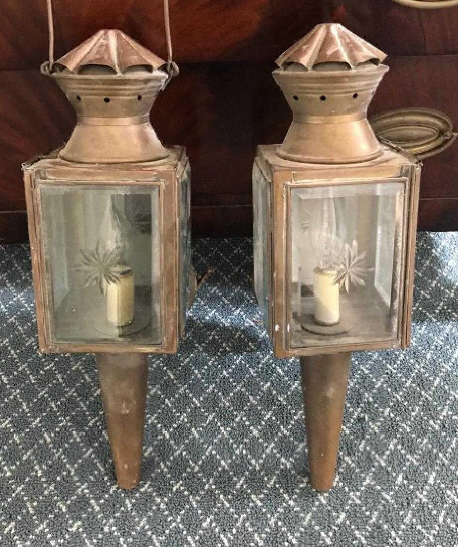 The pair of antique copper carriage or coach lights have been converted to electrified wall sconces, once the property of an historic Hudson River Valley mansion. The bevelled glass windows are decorated with etched or cut glass star-pattern