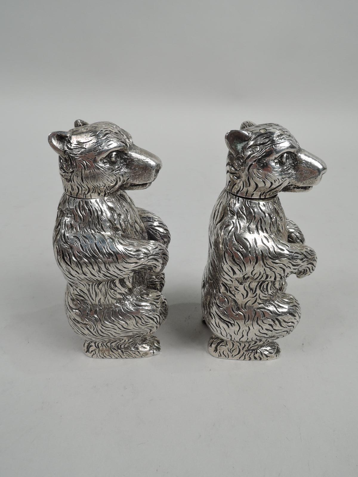 Pair of sterling silver figural animal salt and pepper shakers. Made by George Gebelein in Boston, ca 1920. Each: Bear squatting on hind paws with dangling forepaws. Detachable head with pierced top and vigilant expression. A detailed cast with