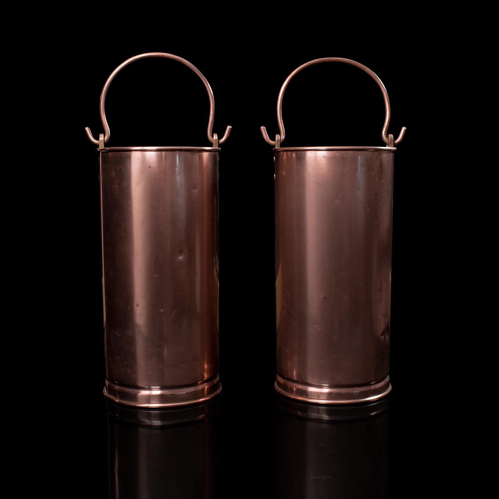 This is a pair of antique stick stands. An English, copper hallway bucket, dating to the early Victorian period, circa 1850.

Attractive tonality and of generous proportion
Displays a desirable aged patina throughout
Hand-rolled copper presents
