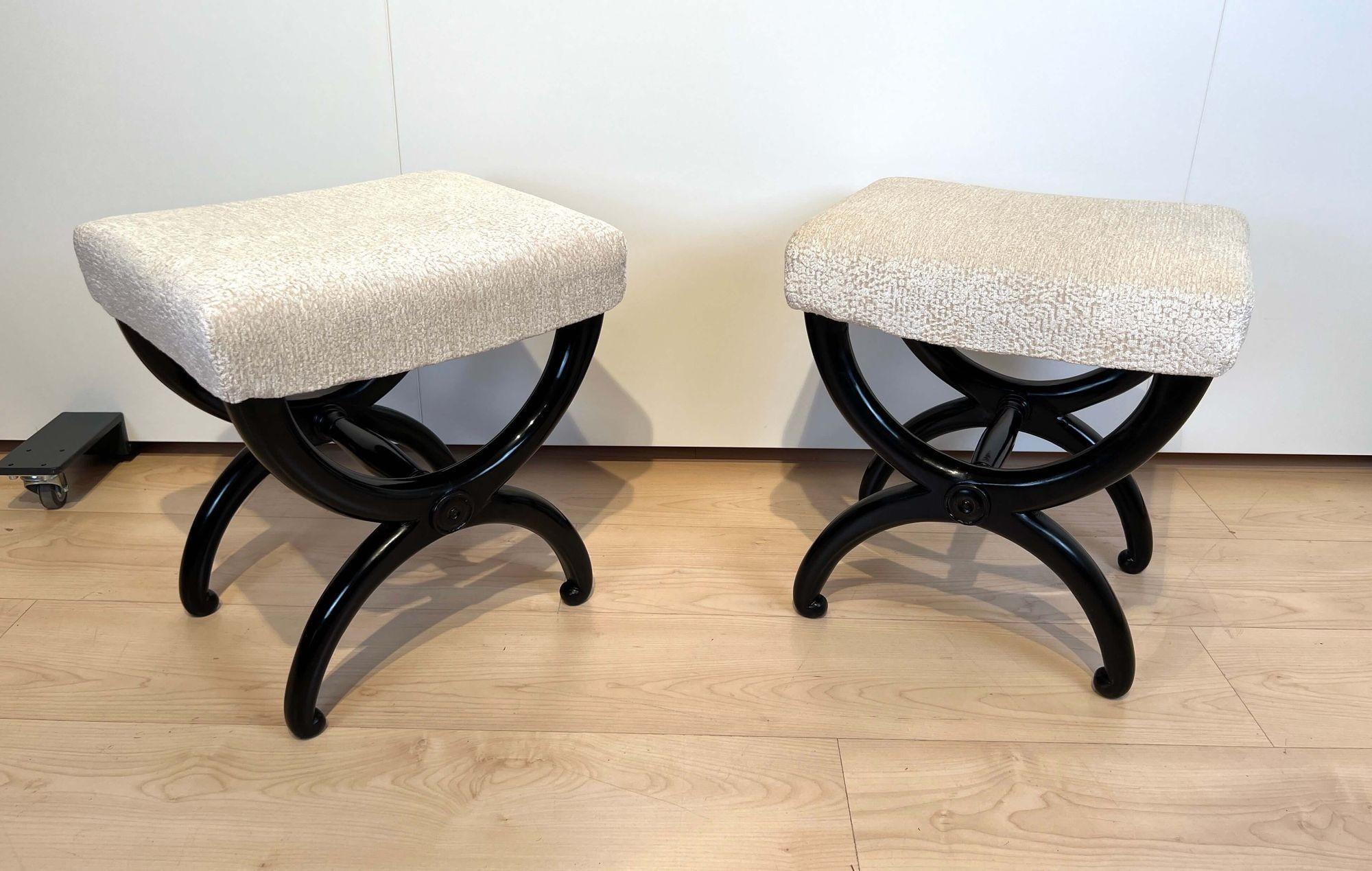 A beautiful pair of petite stools from the french restoration / Biedermeier period.

Solid beech wood, ebonized and polished. Newly upholstered and covered with cream-white structured velvet fabric and double keder. Also for sale