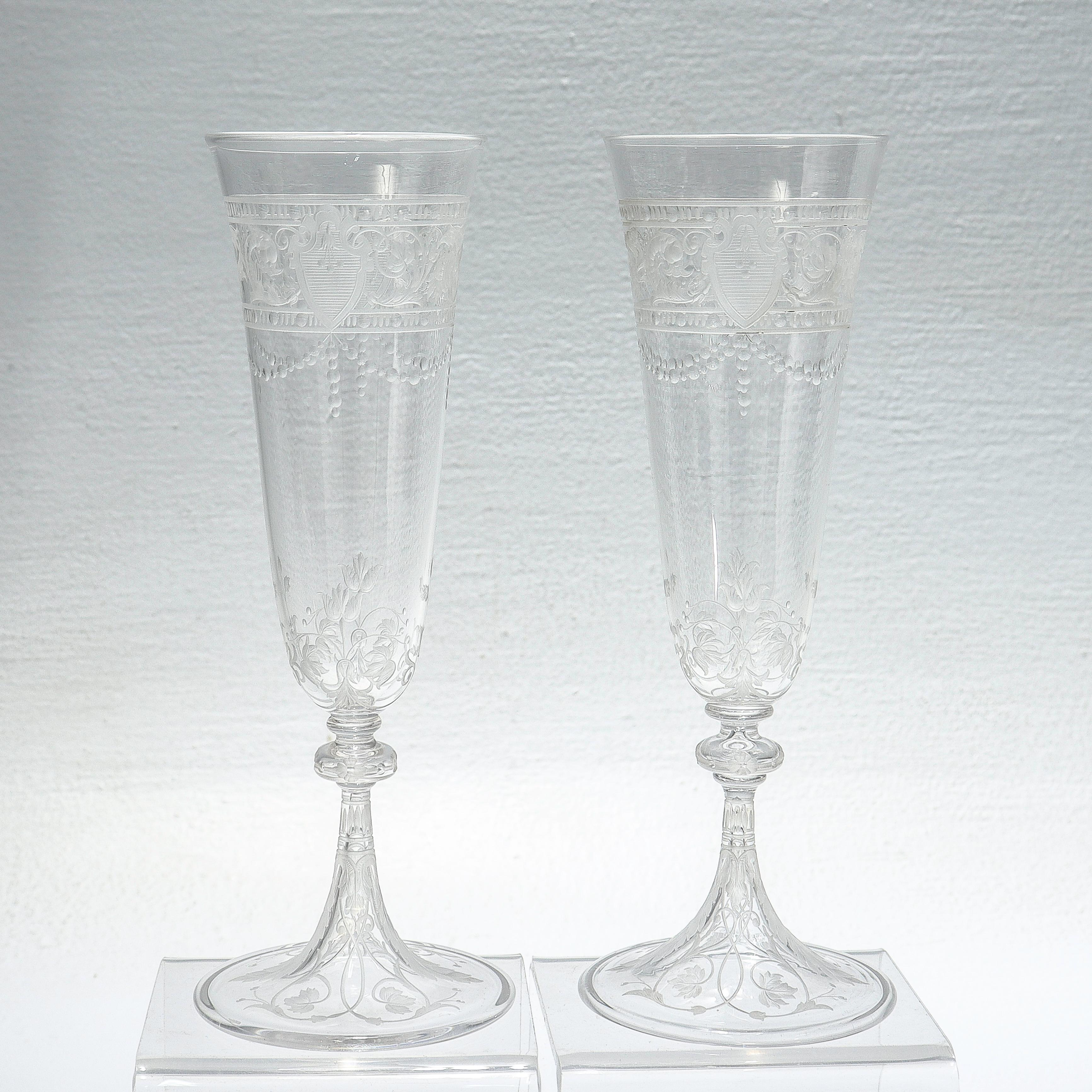 A fine pair or antique etched and engraved glass champagne flutes.

Attributed to Stevens & Williams or Webb.

With engraved & etched designs trelliswork, flowers, and shield devices.

Simply a wonderful pair of English art glass champagnes