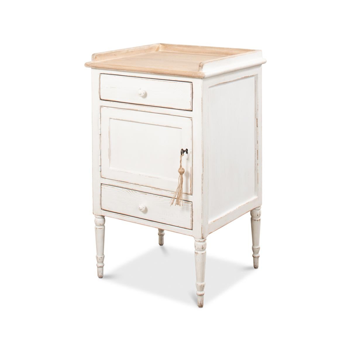 With a natural pine three quarter gallery top, two drawers and cupboard, in an antiqued white painted and distressed finish raised on turned and tapered legs.

Also sold individually.

Dimensions: 20