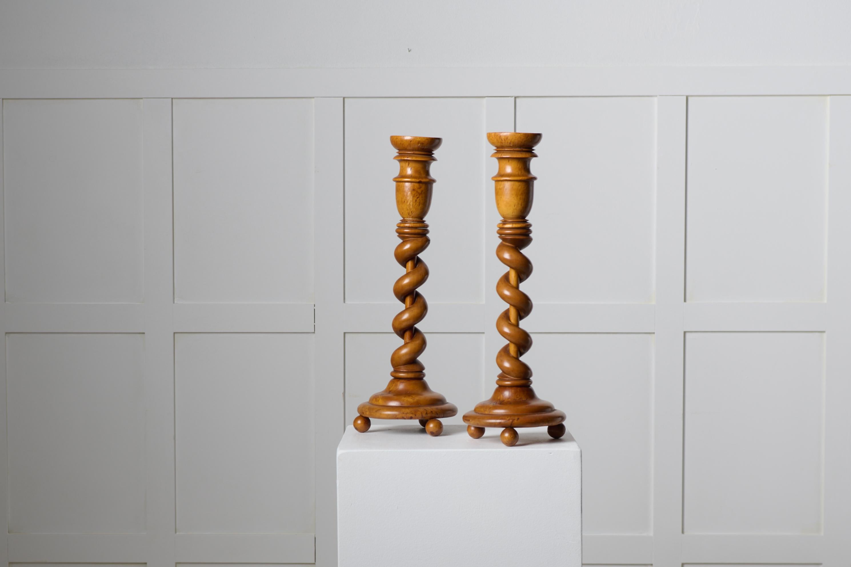 Pair of Swedish empire candlesticks from around 1840 to 1850. The candlesticks are made by hand with a frame in solid birch with elements of birch root in the candleholders and foot. Good vintage condition with smaller traces and marks of use.