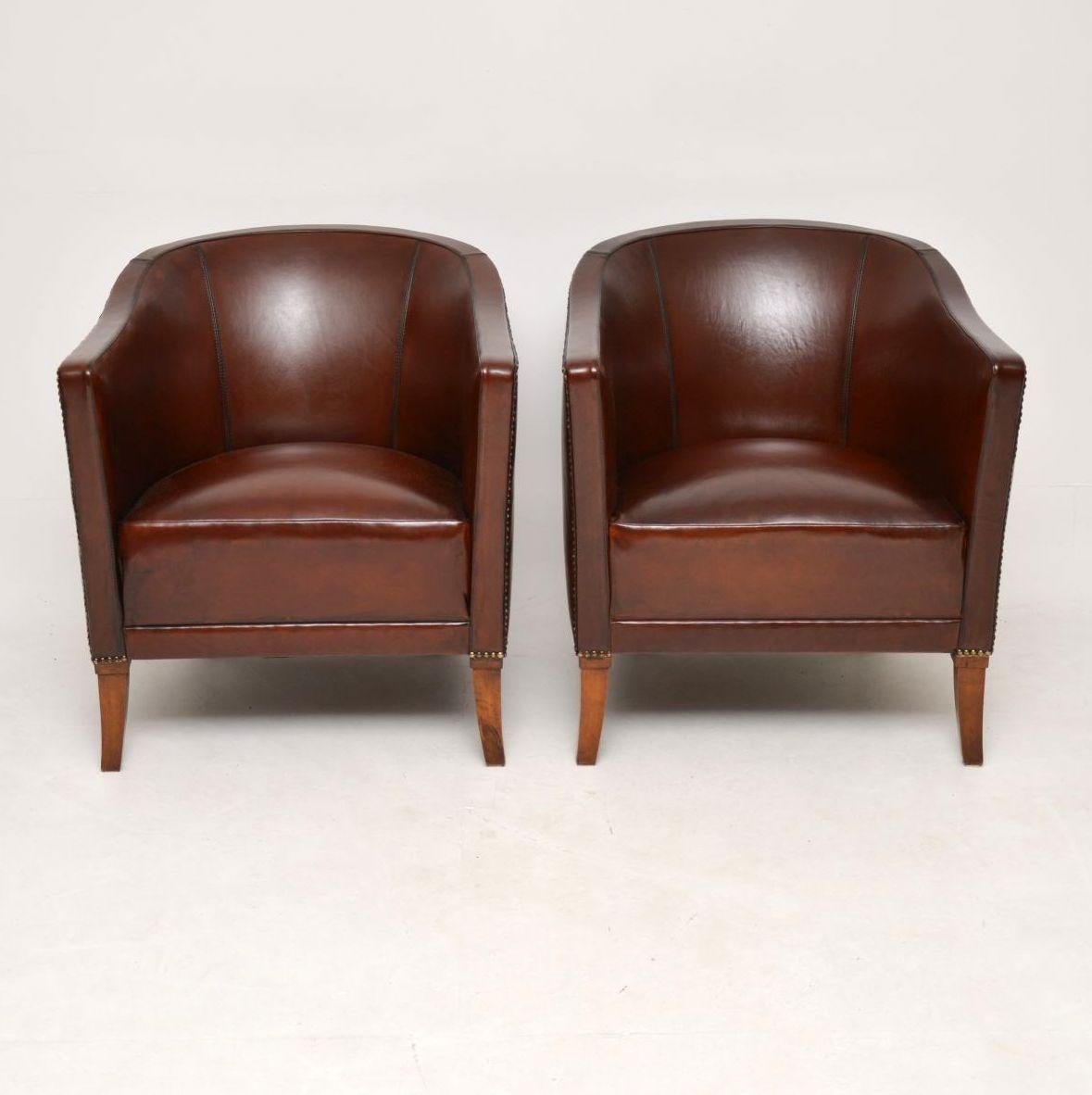 Very stylish pair of antique Swedish curved back leather armchairs in good condition and dating to circa 1890-1910 period. These chairs are a really nice model and very comfortable too. The leather has a lovely rich colour. It’s hand tacked onto the