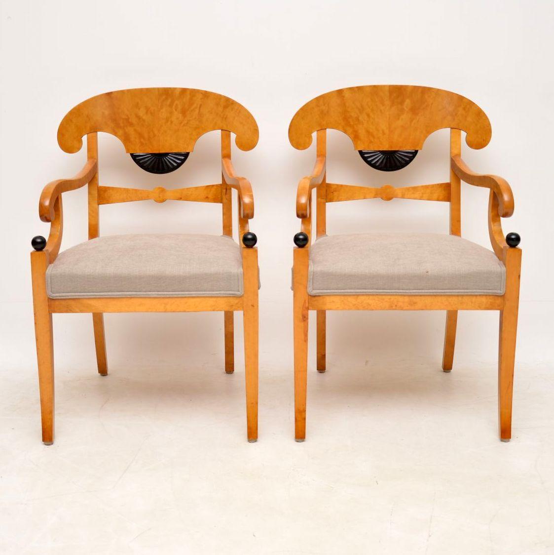 These are one of the nicest pairs of Swedish antique Biedermeier armchairs I've had. The wood is satin birch and is a wonderful blond color. They have Trafalgar backs, scroll over arms, wide newly upholstered seats and sit on sabre legs. There is a