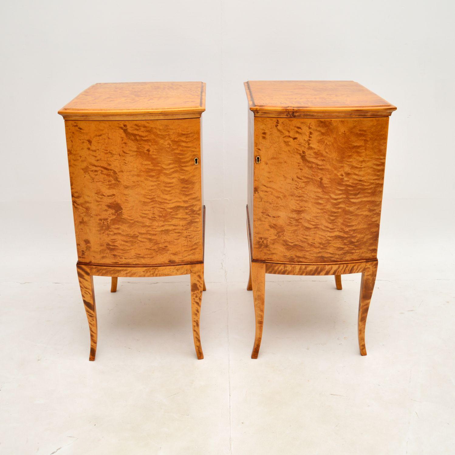 A large and very impressive pair of antique Swedish satin birch bedside cabinets. They were recently imported from Sweden, and date from around the 1900-1910 period.

The satin birch grain patterns and colour tones are absolutely gorgeous, they sit