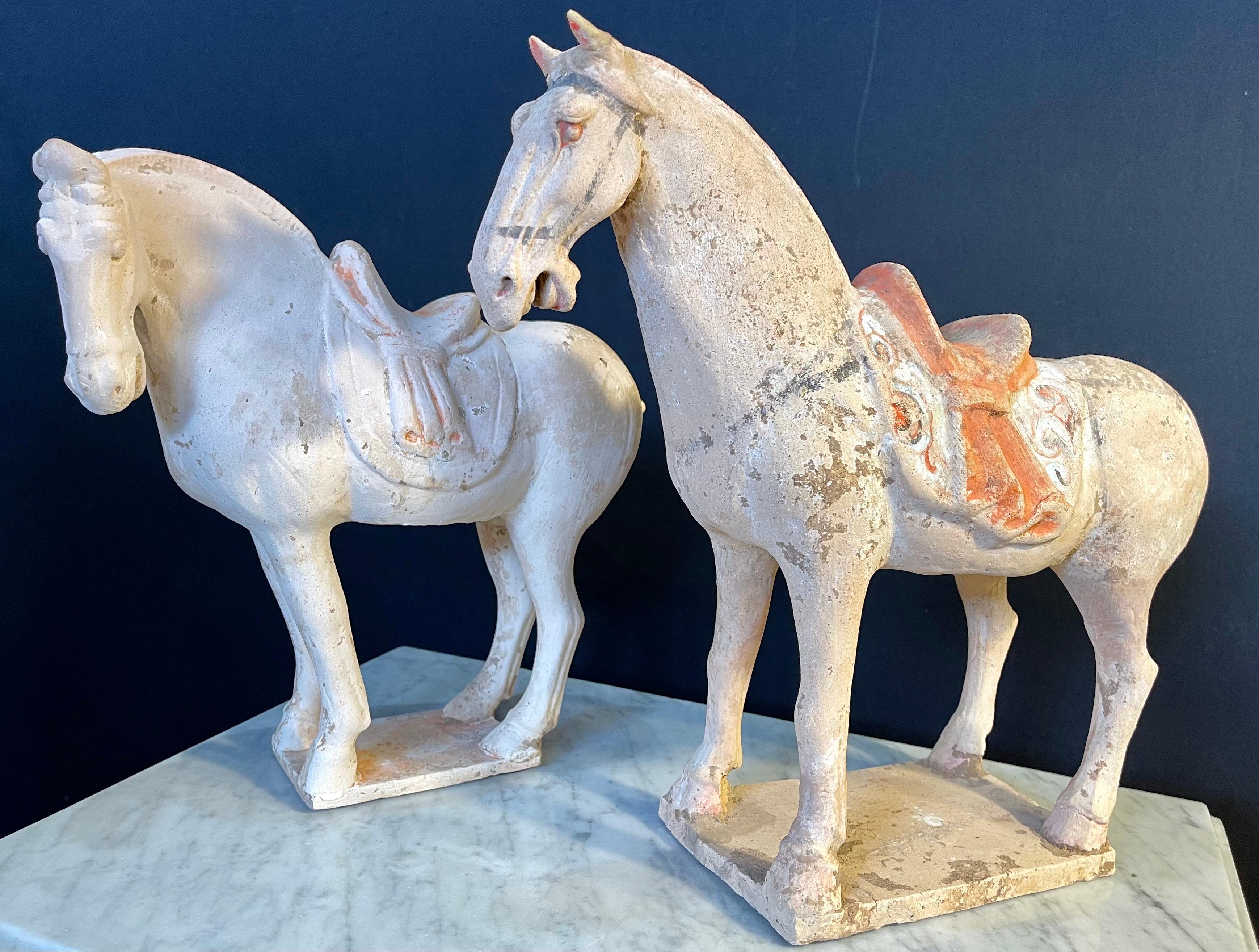 Pair of tang style pottery horses. Roof tile manner, both left facing with matching scalloped saddle drapes (one broken and missing), nice polychrome. One tail broken and repaired. Price accordingly.
1qS.