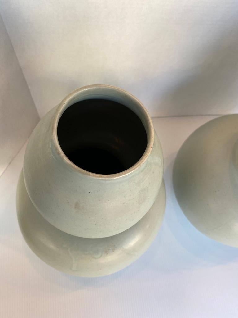 This pair of antique Thai double gourd vases is a celadon matte glaze these vases where in the Adrianne Vittadini collection in South Hampton Estate soft to the eyes and rich looking! Signed on the bottom 

A softer look than the photo!