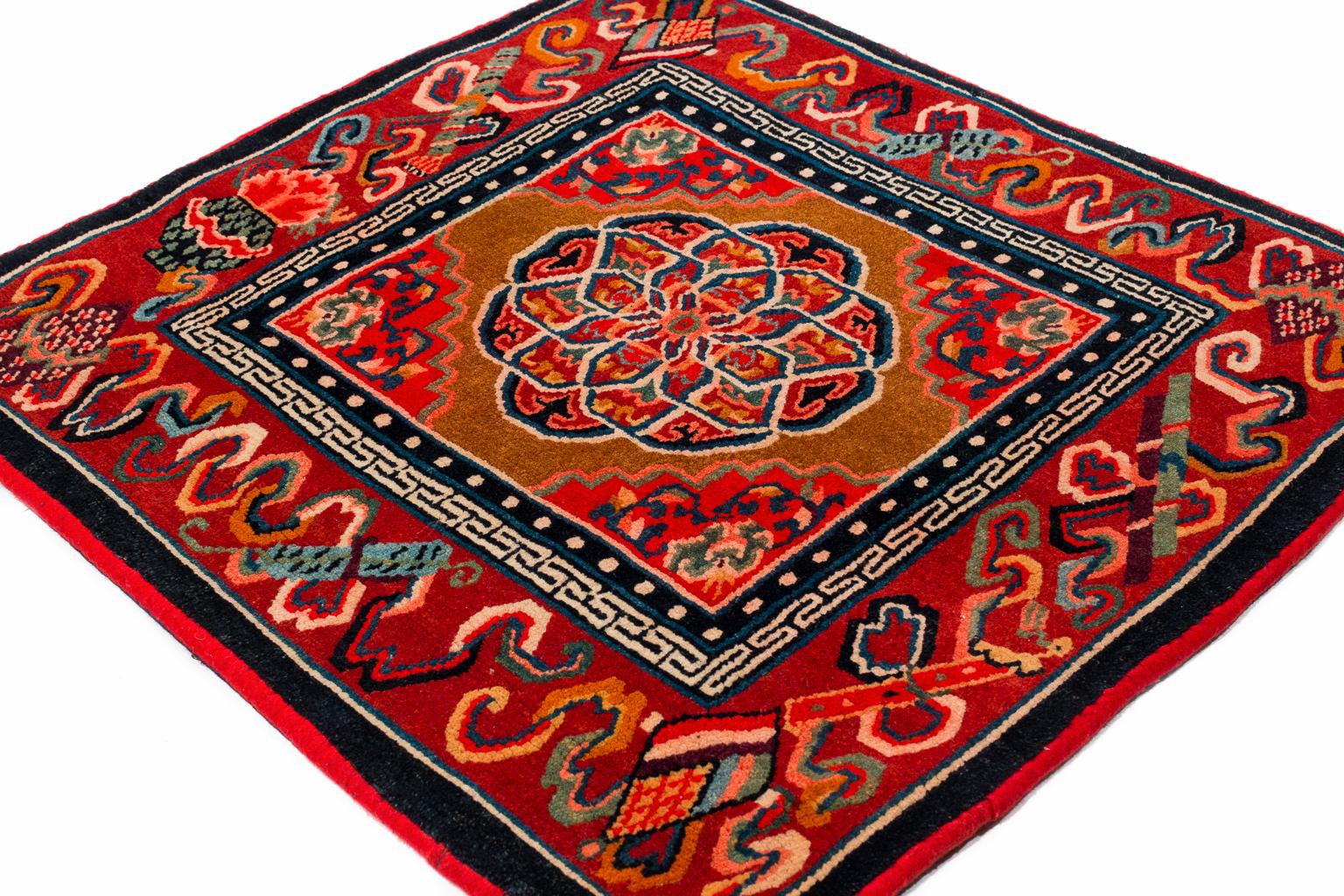 Pair of antique meditation mats with beautiful color, handmade using all natural dyes and fine weaving techniques. Hand-knotted from Tibetan Himalayan wool, this rug was executed by a master weaver. The border and floral details are highly complex